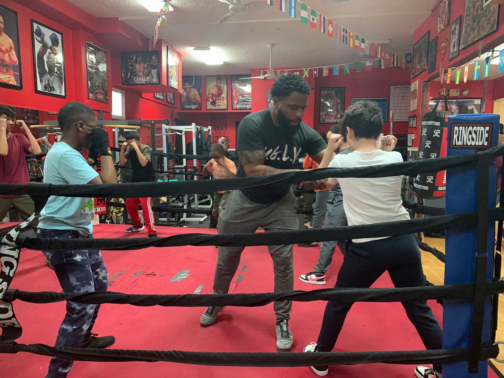 A group of people are standing in a boxing ring.