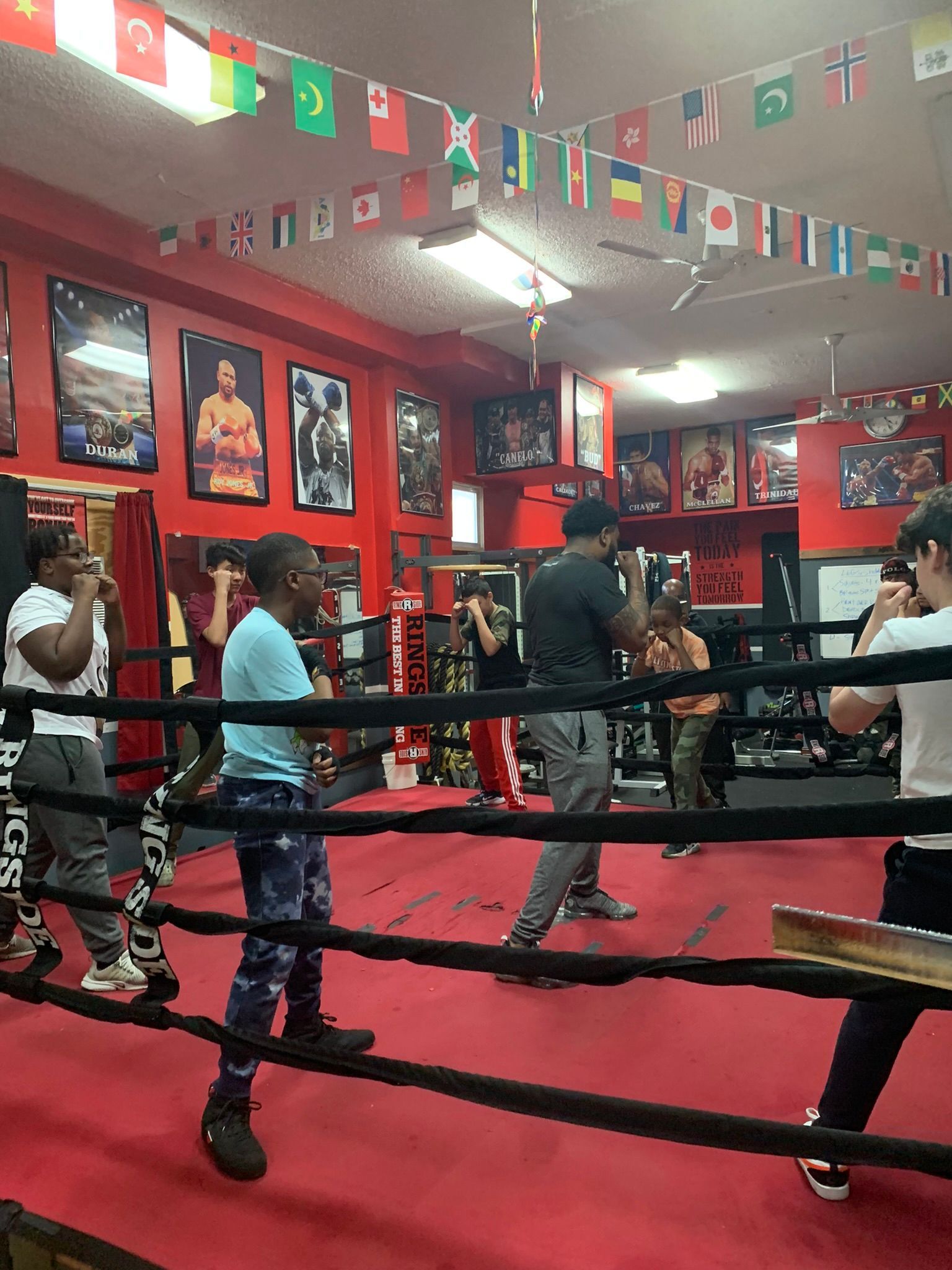 A group of people are standing in a boxing ring.