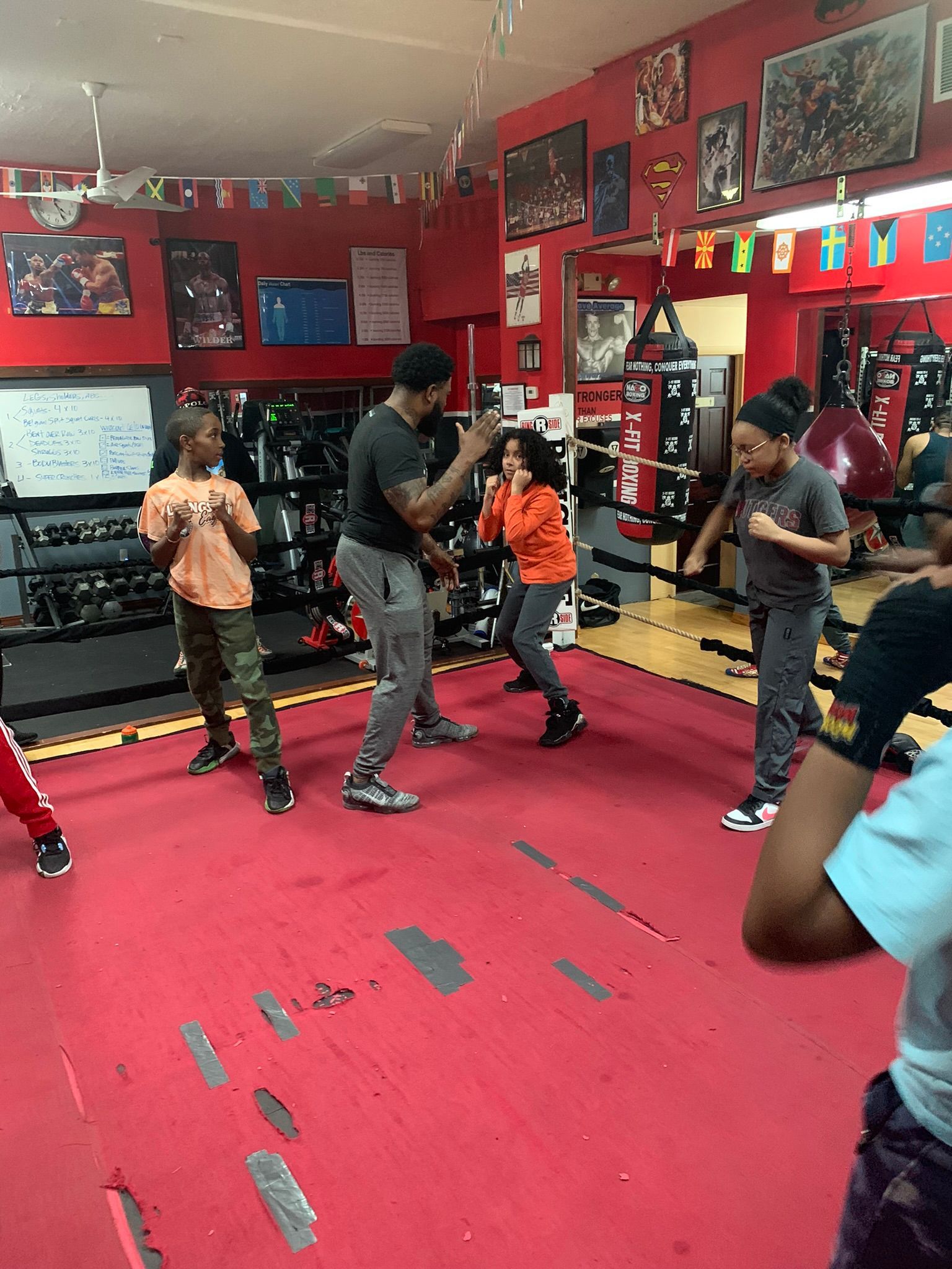 A group of people are boxing in a gym.