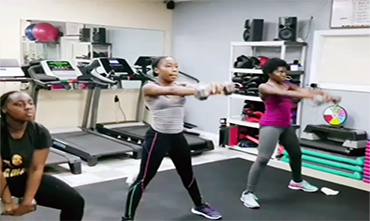 A group of women are doing exercises in a gym.
