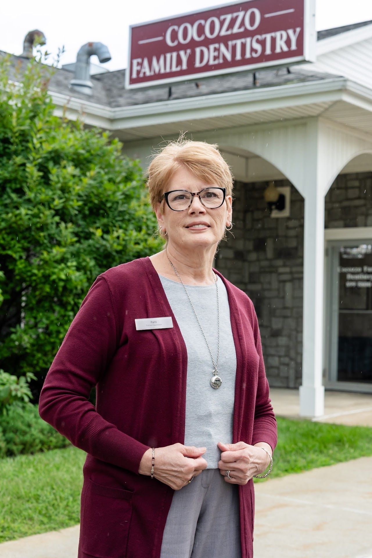 Patti, treatment plan coordinator, outside Cocozzo Family Dentistry in Malta, NY