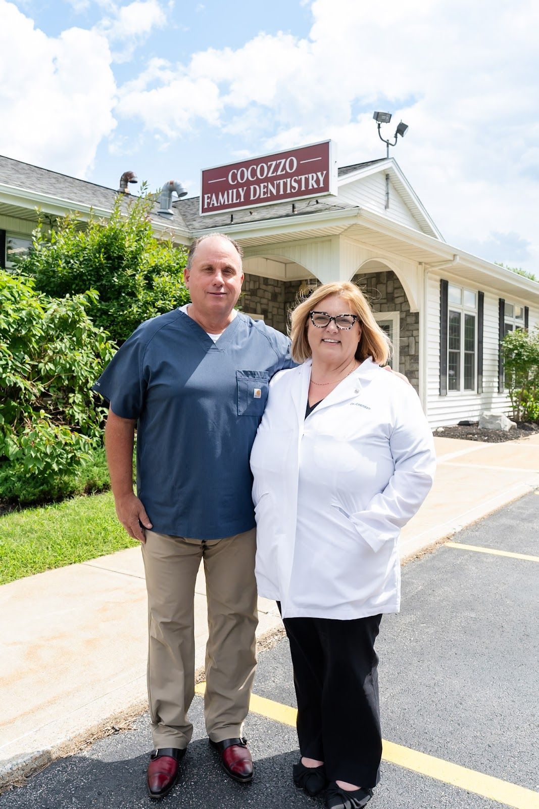 Dr. Christina Cocozzo and Dr. Polsinello outside Cocozzo Family Dentistry in Malta, NY