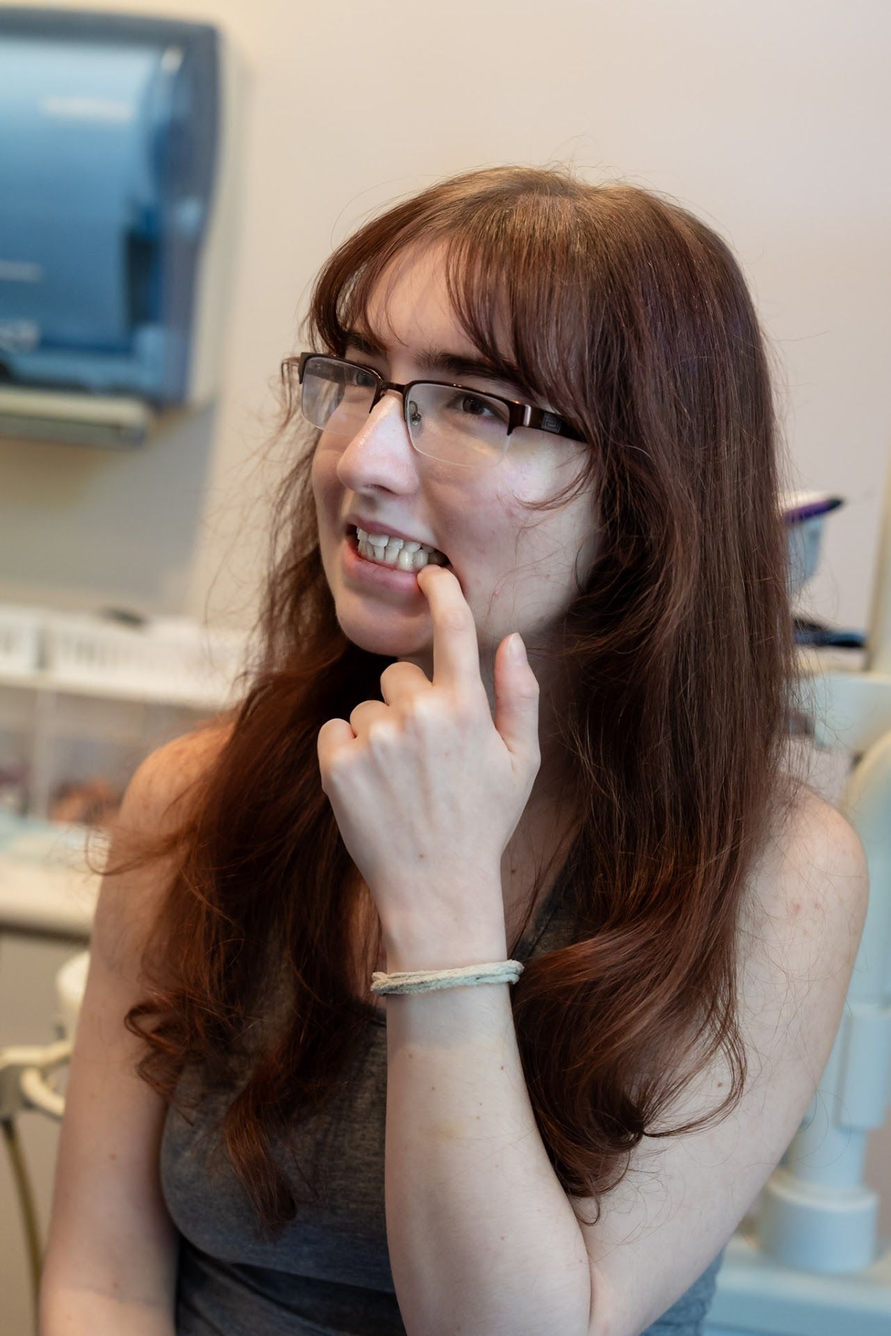 Patient holding her cheek from tooth pain at Cocozzo Family Dentistry in Malta, NY