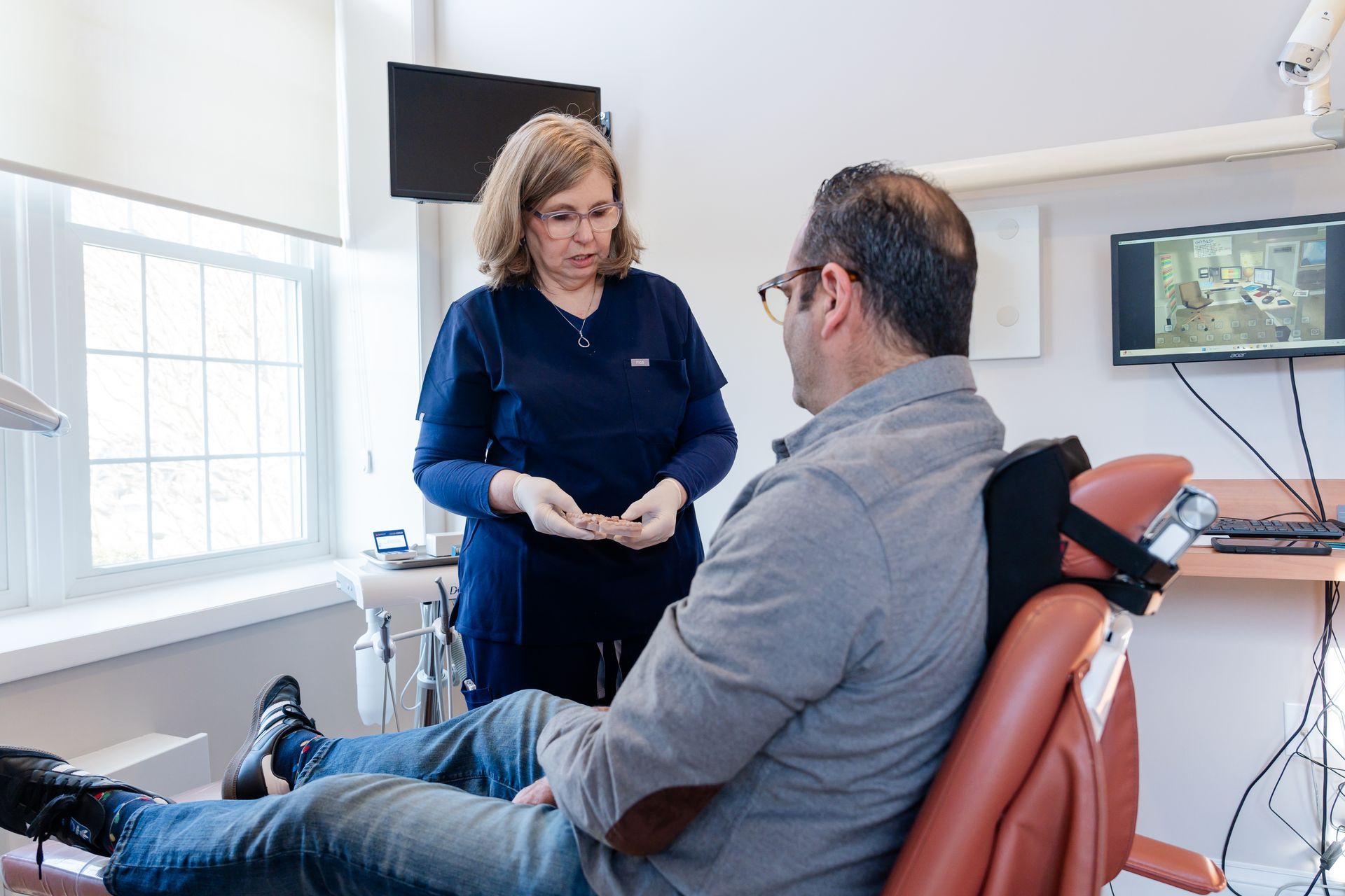 Implant patient relaxing in the treatment chair before his visit at Cocozzo Family Dentistry in Malta, NY