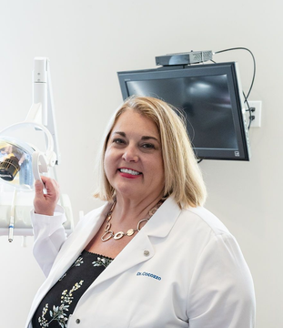 Dr. Christina Cocozzo smiling in her operatory in Malta, NY