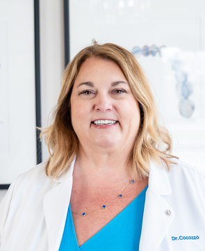 Dr. Christina Cocozzo in her white coat at her Malta, NY practice