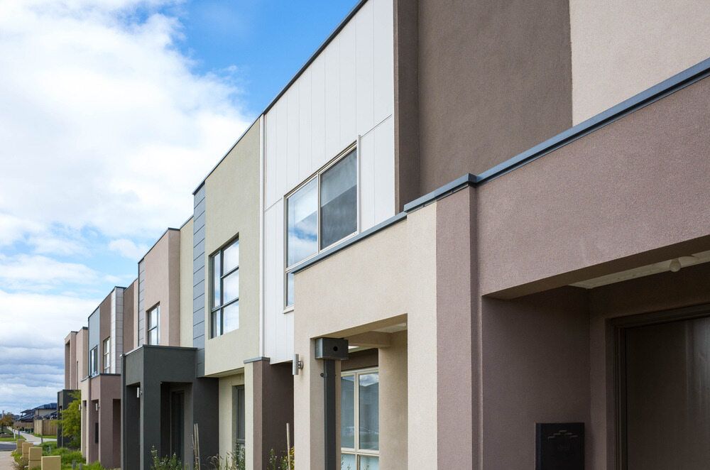 A Row of Houses in a Residential Area With a Blue Sky in the Background — Key2 Conveyancing In Tuncurry, NSW