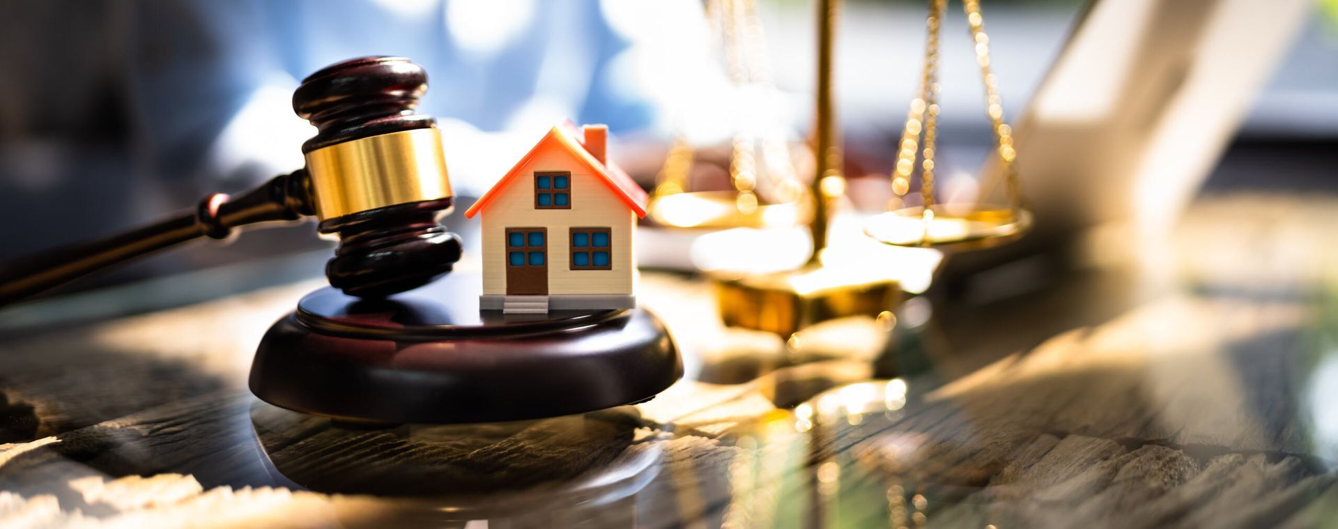A Small House is Sitting on Top of a Wooden Gavel — Key2 Conveyancing In Old Bar, NSW