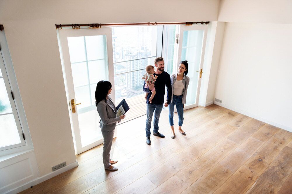 A Family is Looking at a House With a Real Estate Agent — Key2 Conveyancing In Forster, NSW