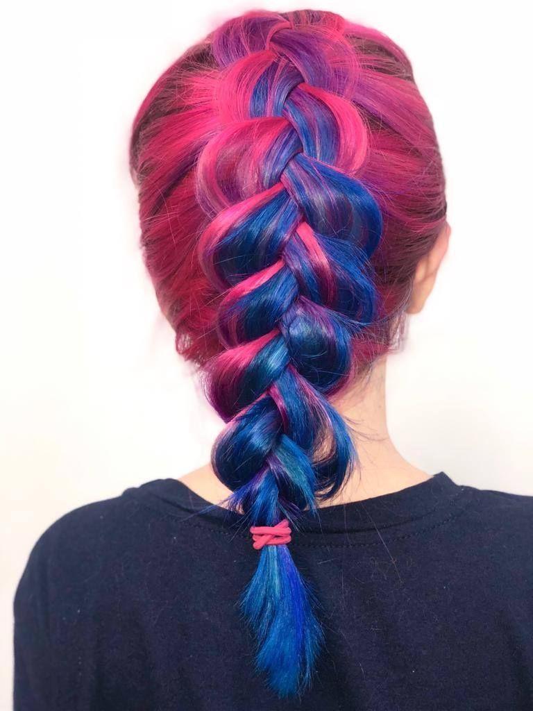 A woman with pink and blue hair in a braid