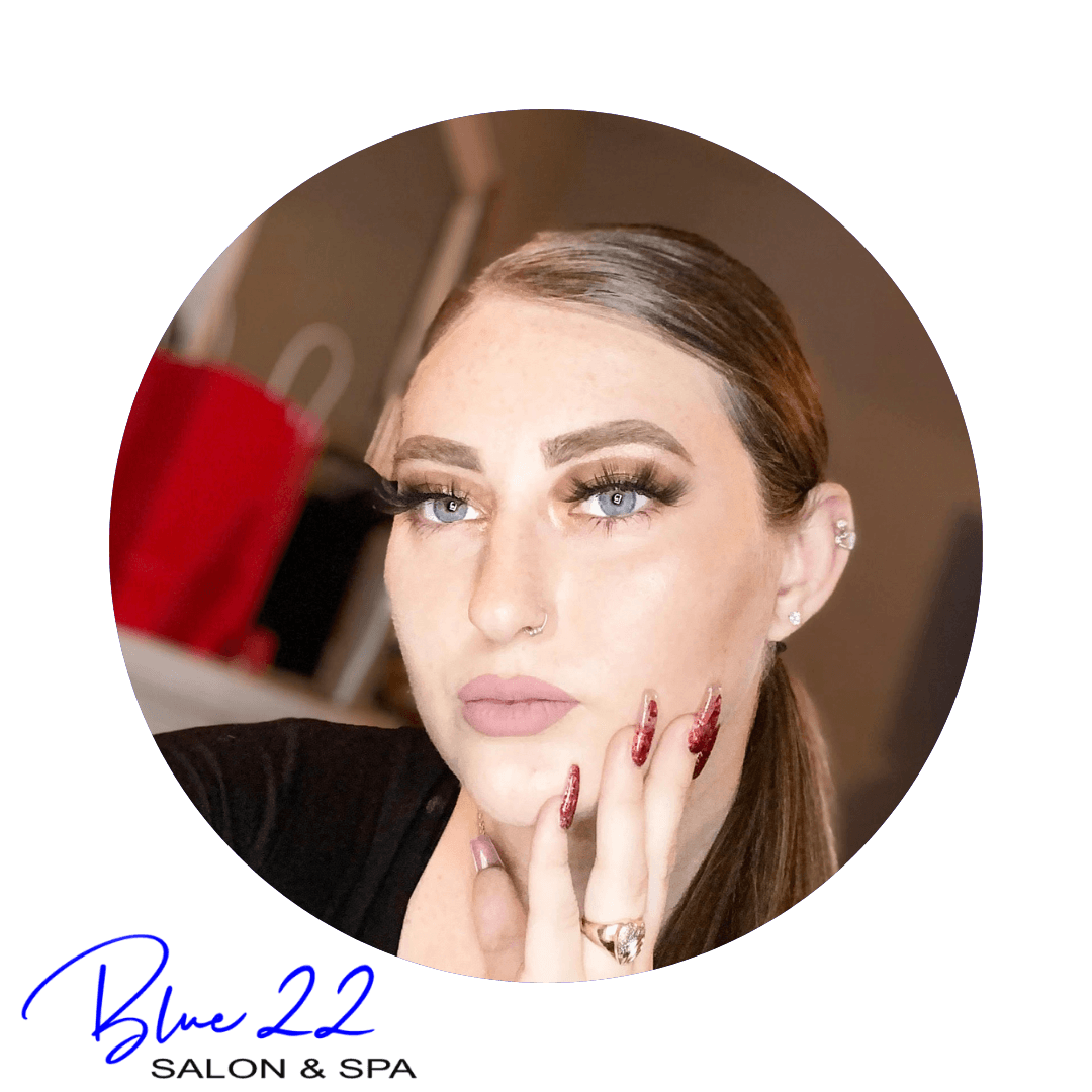 Blue 22 Salon & Spa Portrait logo of a woman with styled makeup, hand on cheek, and “Blue 22 Salon Spa” text