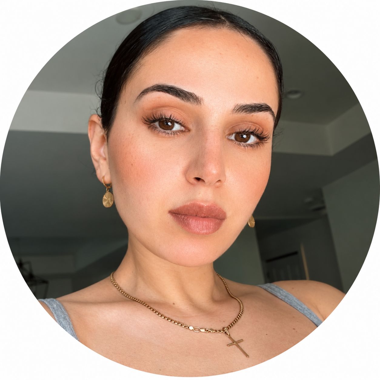 Blue 22 Salon & Spa Close-up selfie of a person with dark hair, subtle makeup, and gold jewelry indoors