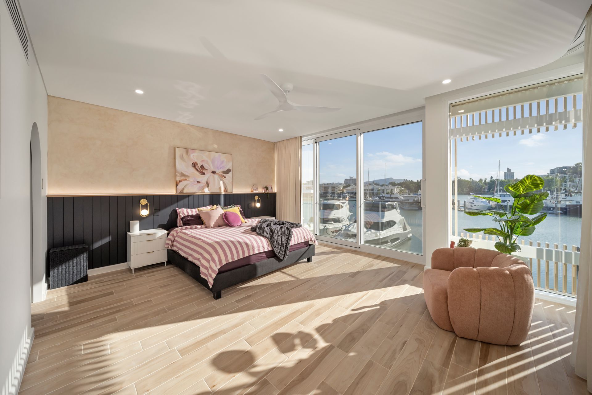 Bright Bedroom With Striped Bed — Simon Bell Constructions in Alice River, QLD