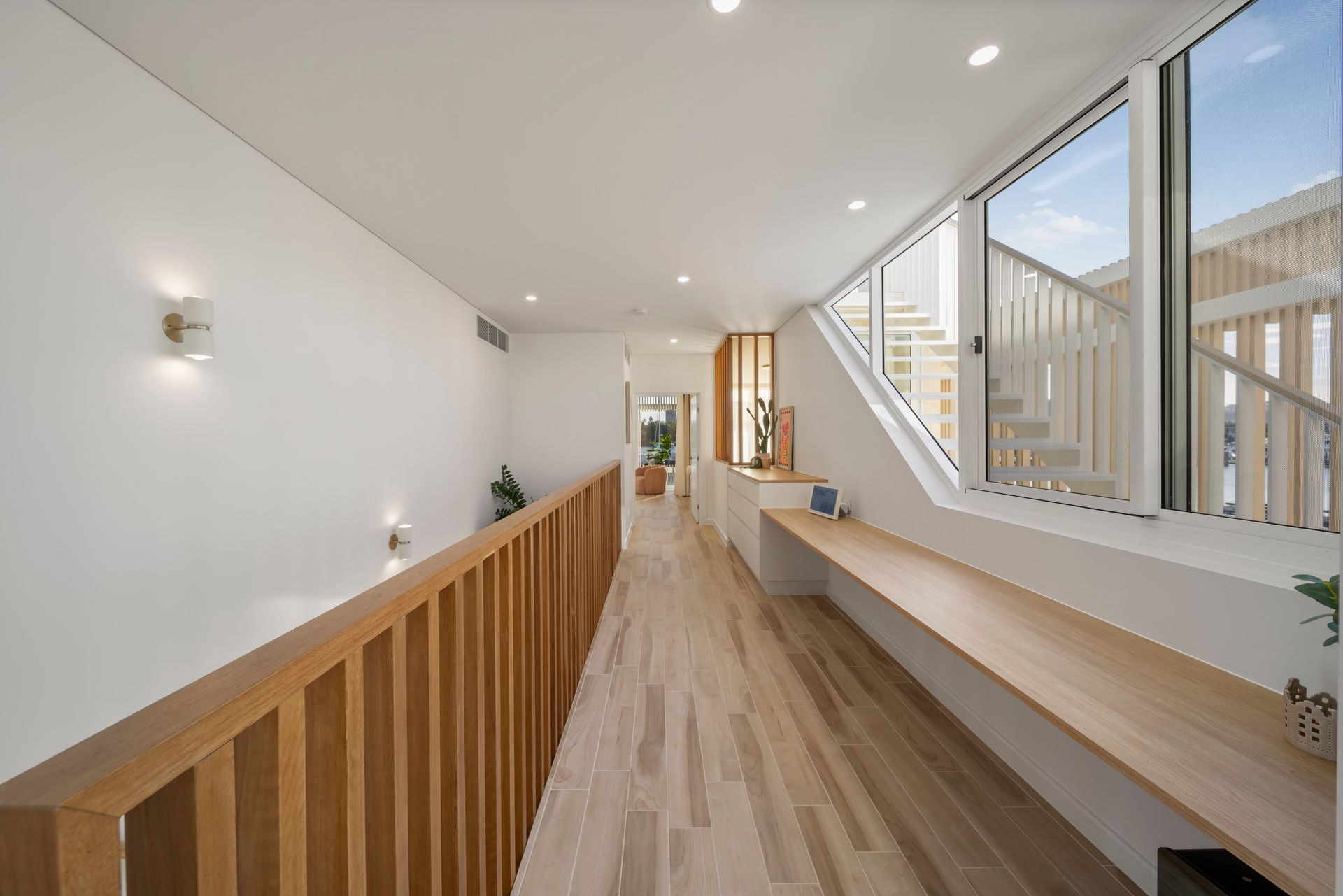 Bright Modern Hallway With Wood Flooring, White Walls — Simon Bell Constructions in Alice River, QLD