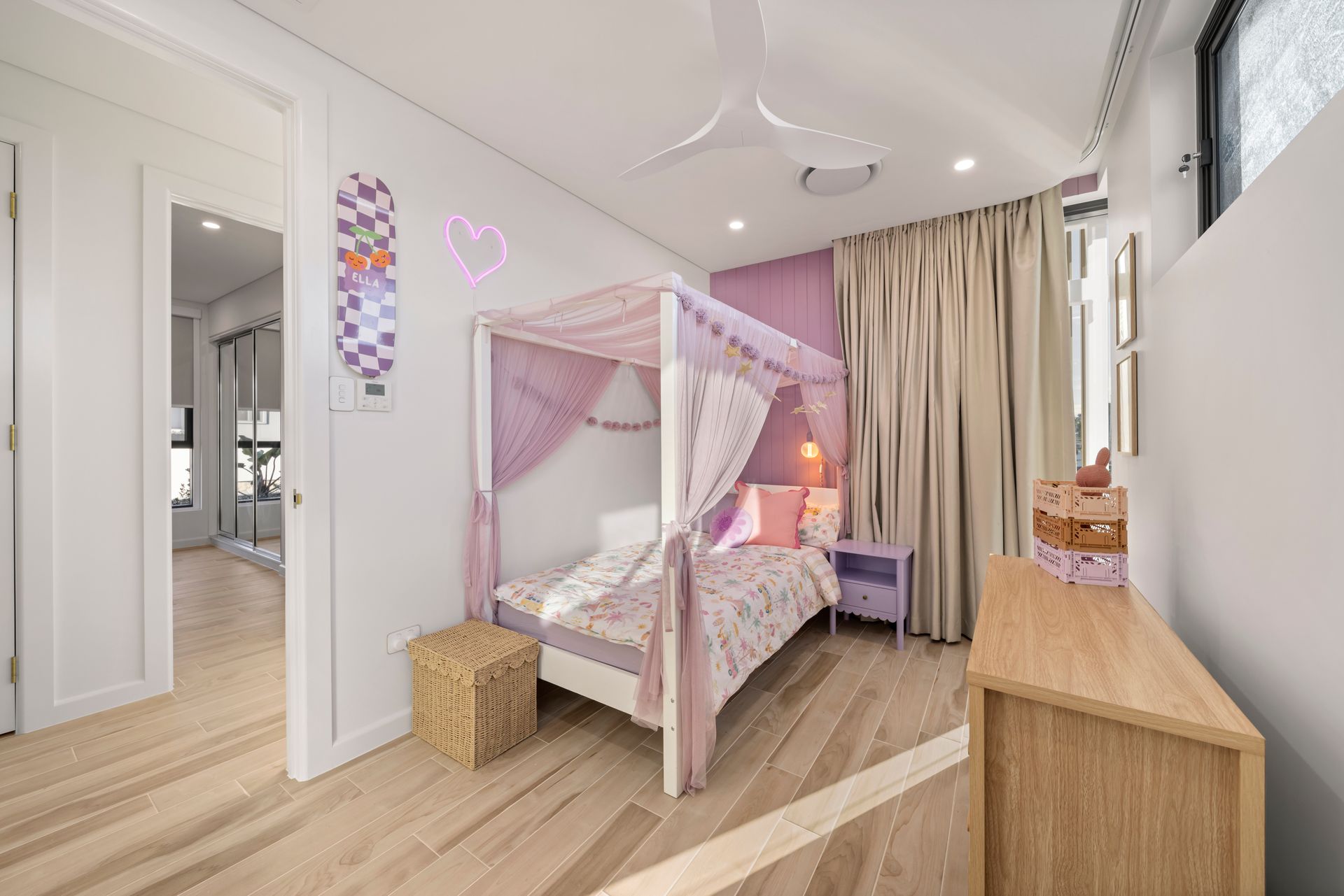 Bright Pink Canopy Bed in a Modern Nursery With Wood Flooring — Simon Bell Constructions in Alice River, QLD