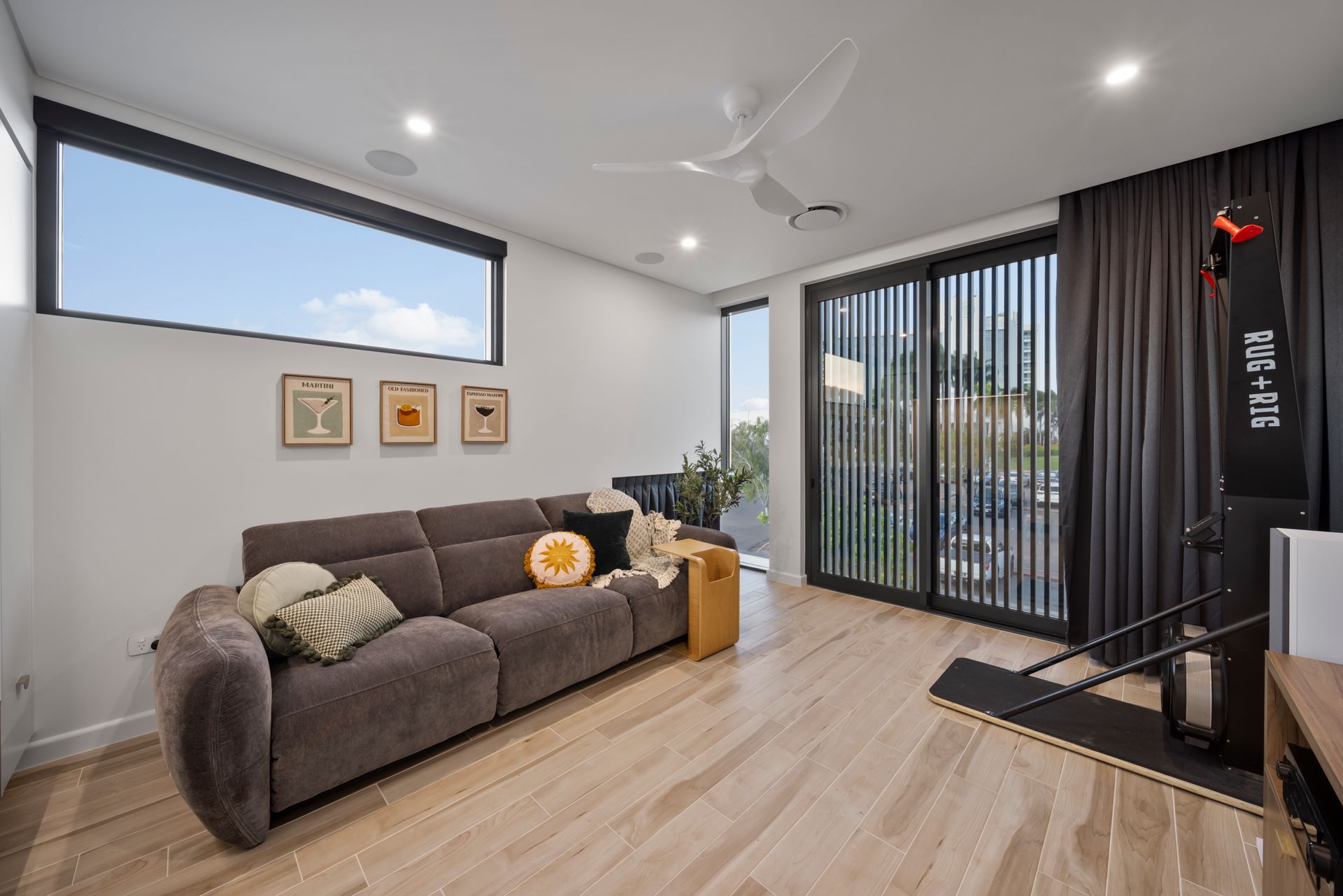 Modern Living Room With Gray Sofa, Wall Art, Light Wood Floor — Simon Bell Constructions in Alice River, QLD