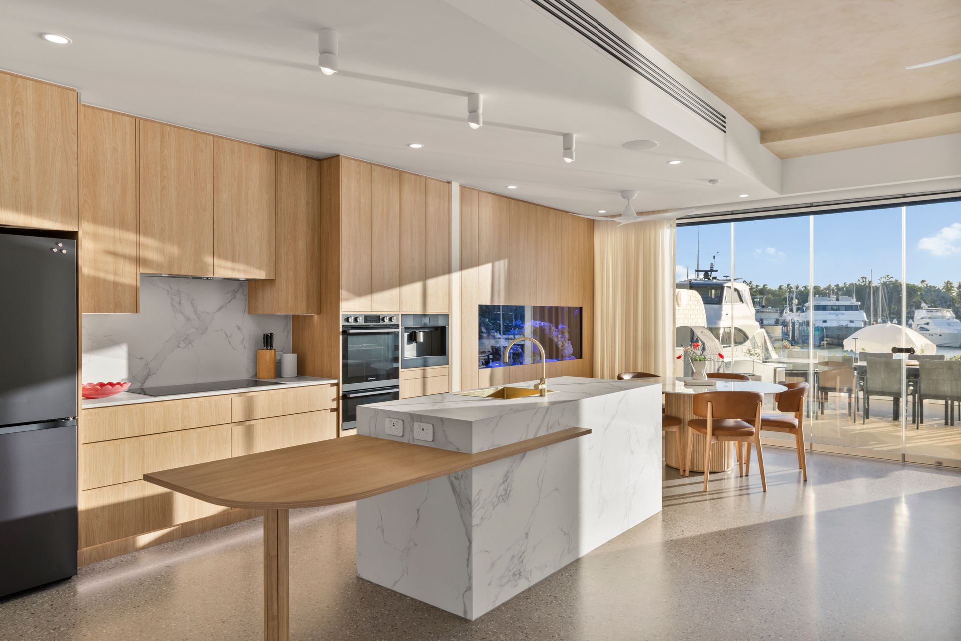 Modern Open-plan Kitchen and Dining Area With Wood Finishes — Simon Bell Constructions in Alice River, QLD