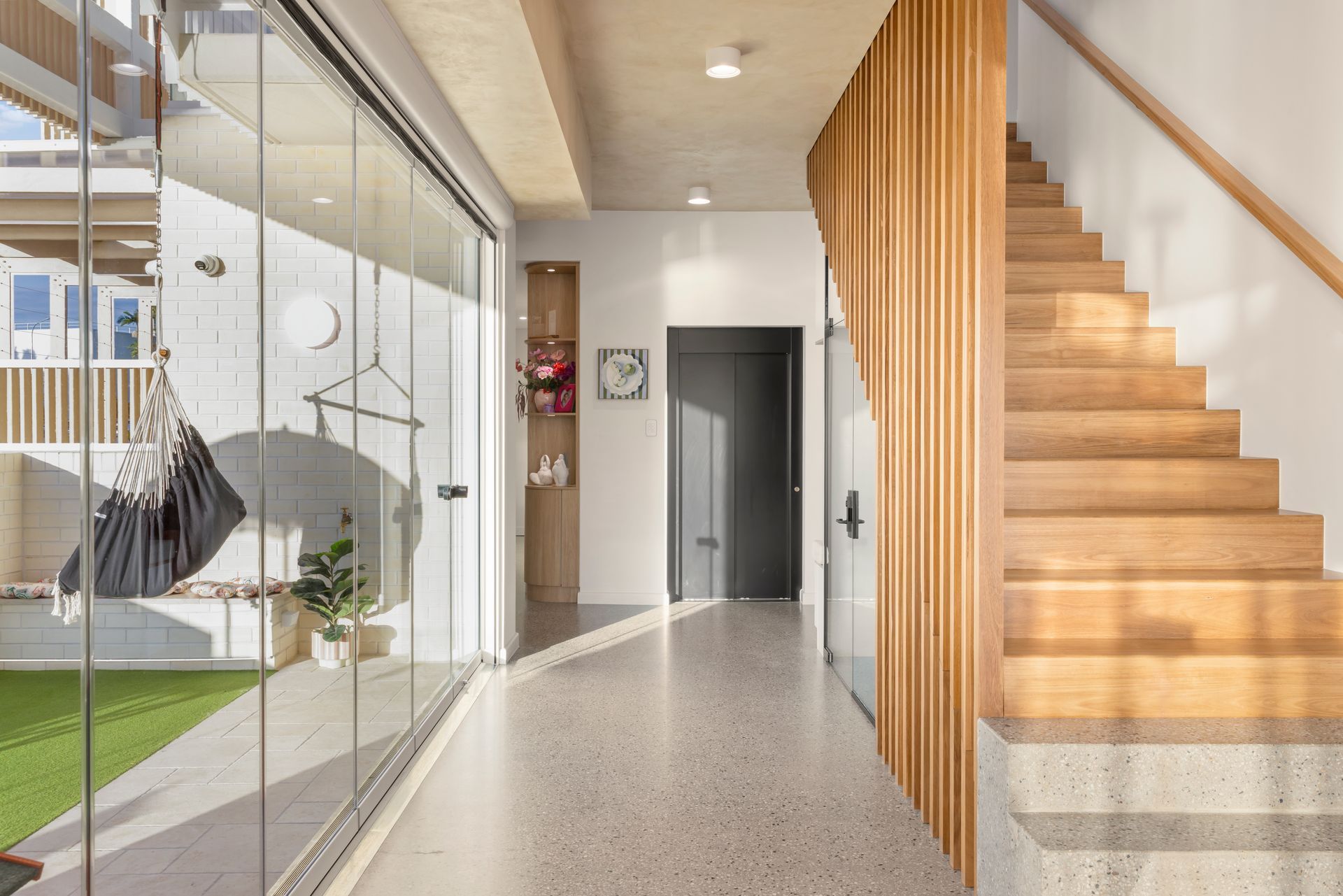 Modern Entryway With Terrazzo Floor, Glass Wall — Simon Bell Constructions in Alice River, QLD