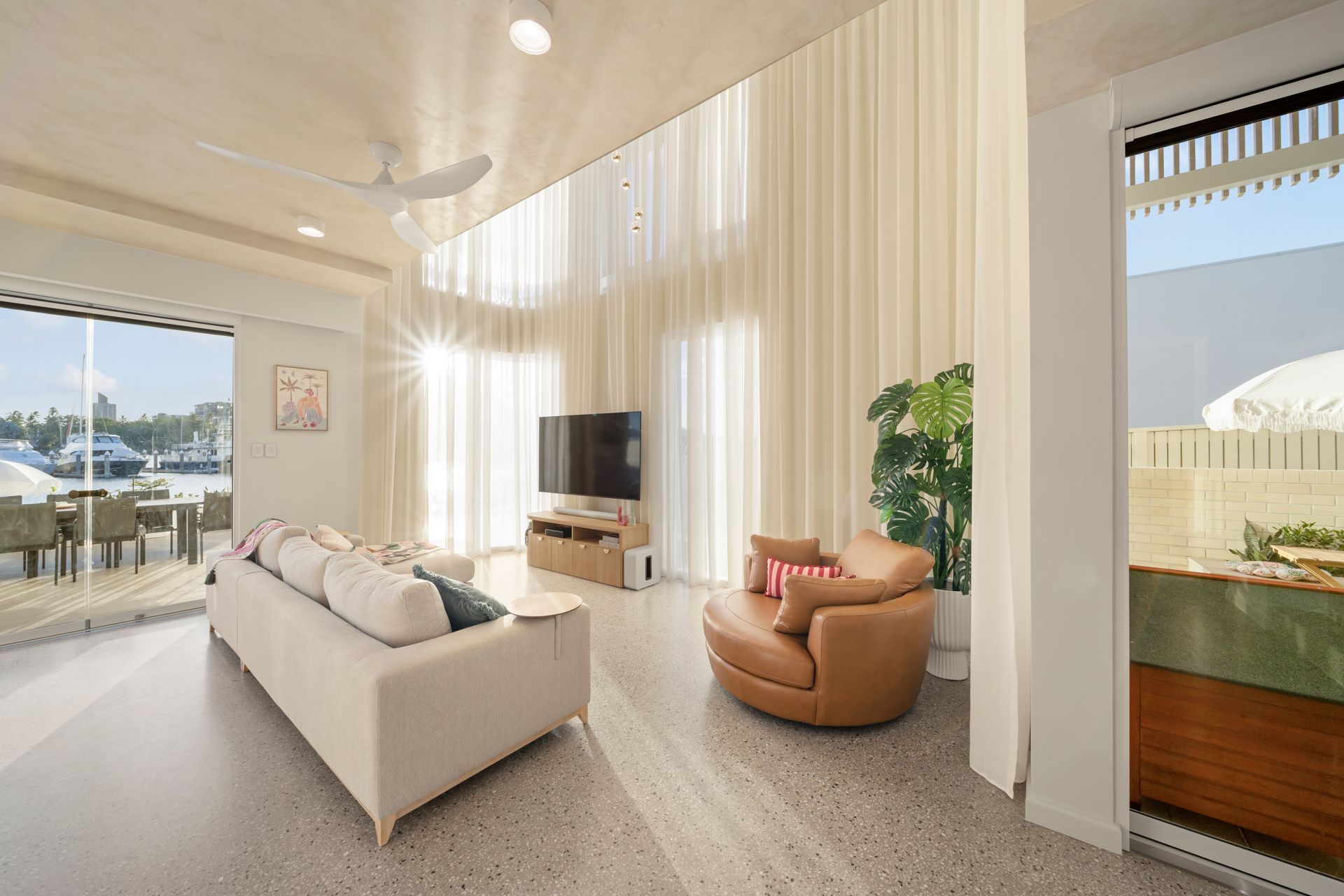 Bright Modern Living Room With Beige Sofa, Tan Chair — Simon Bell Constructions in Alice River, QLD