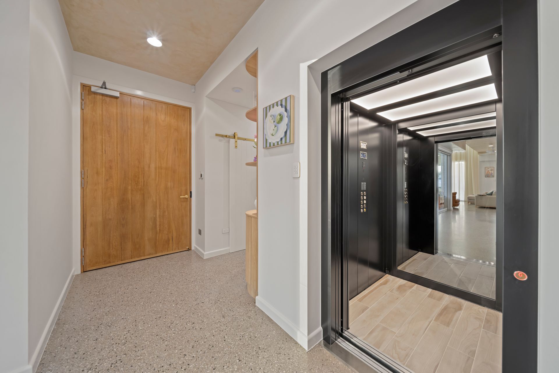 Hallway With an Open Elevator, Wood Door — Simon Bell Constructions in Alice River, QLD