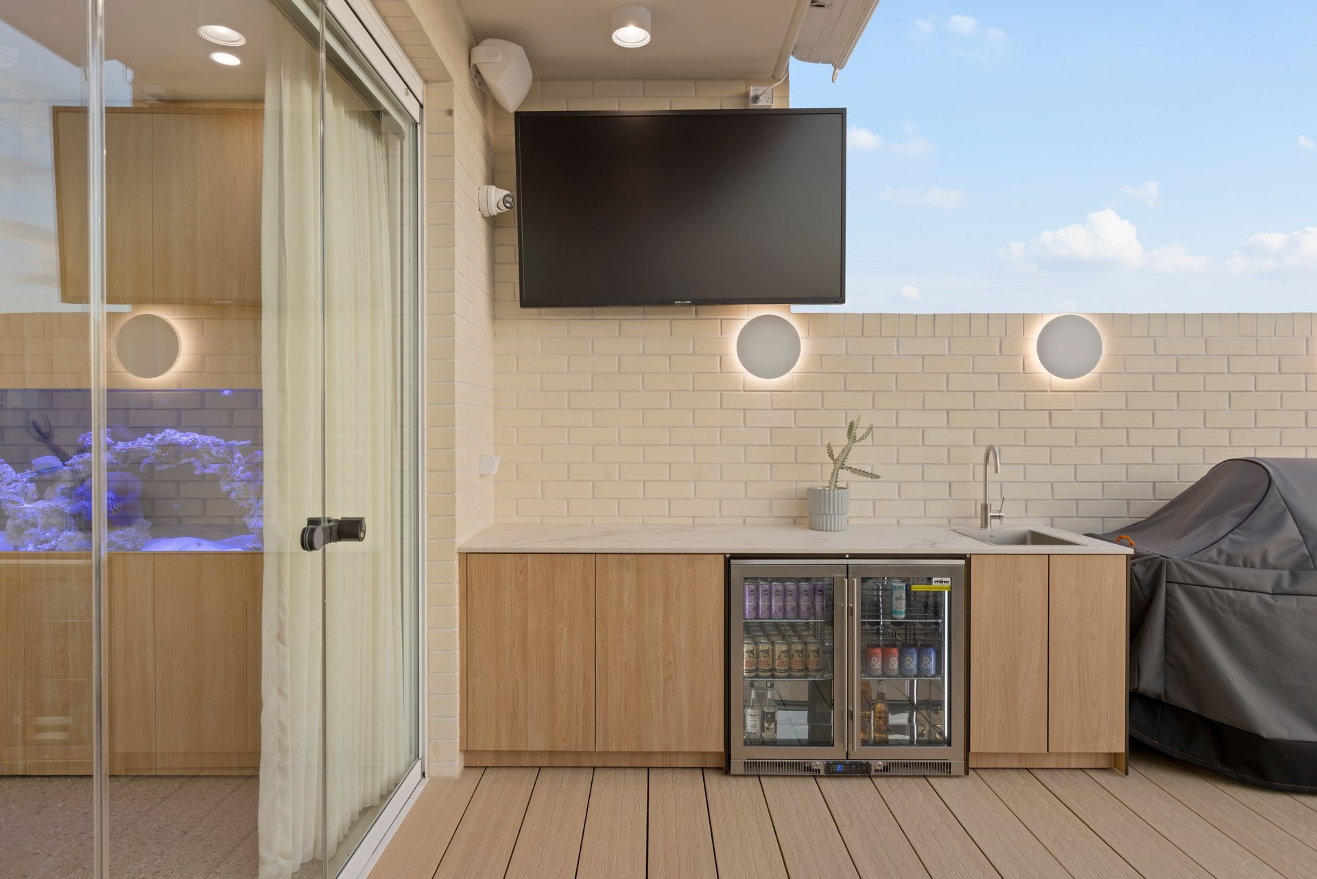 Outdoor Patio With Wall-mounted TV — Simon Bell Constructions in Alice River, QLD