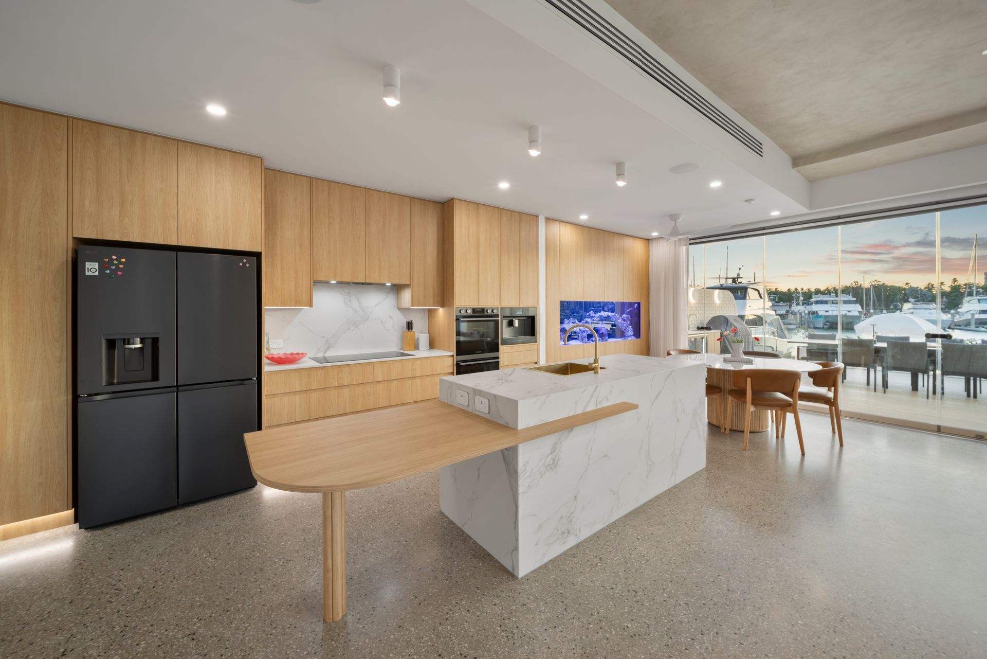 Modern Kitchen With Wood Cabinets — Simon Bell Constructions in Alice River, QLD