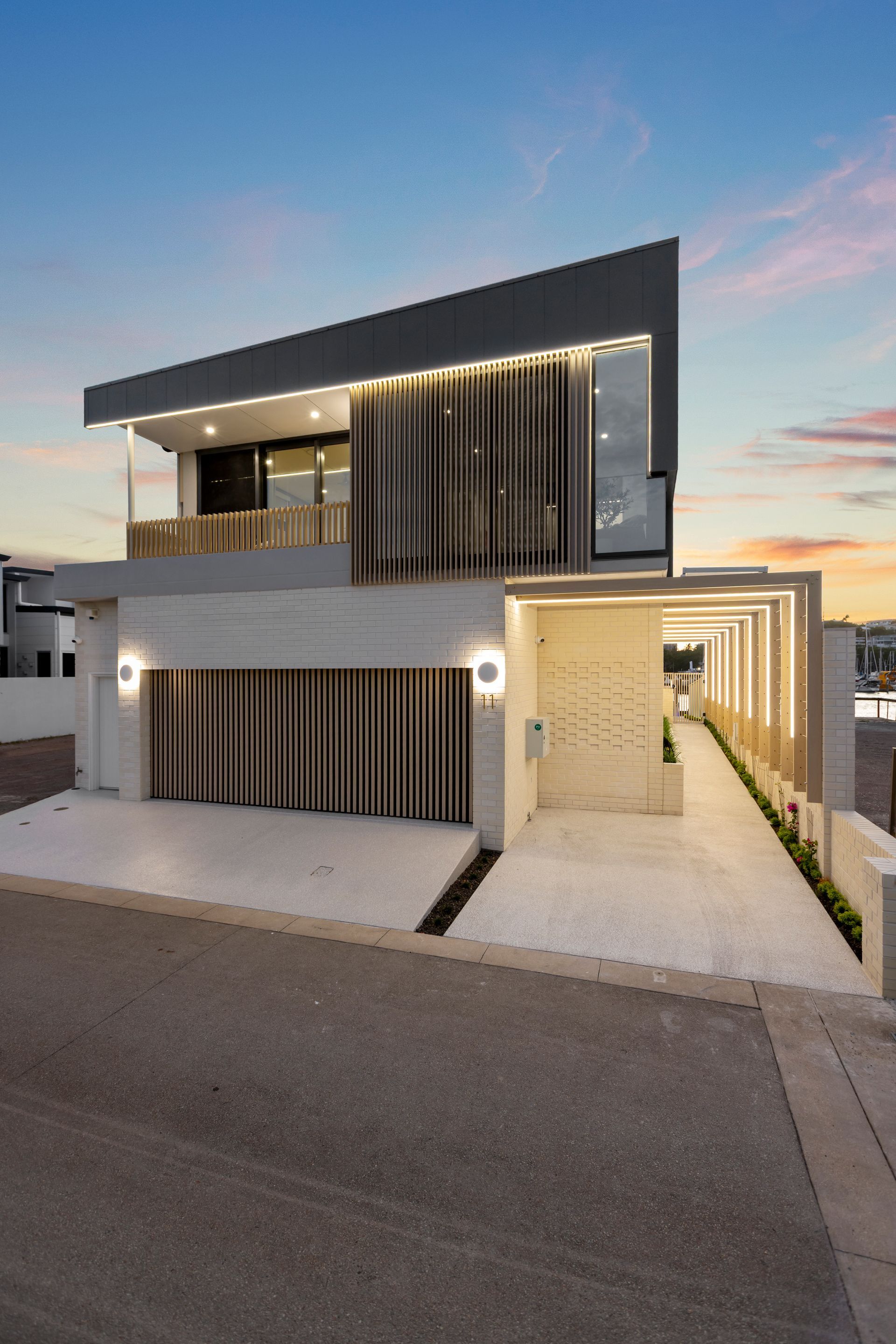 Modern Two-story House With Vertical Wood Slats — Simon Bell Constructions in Alice River, QLD