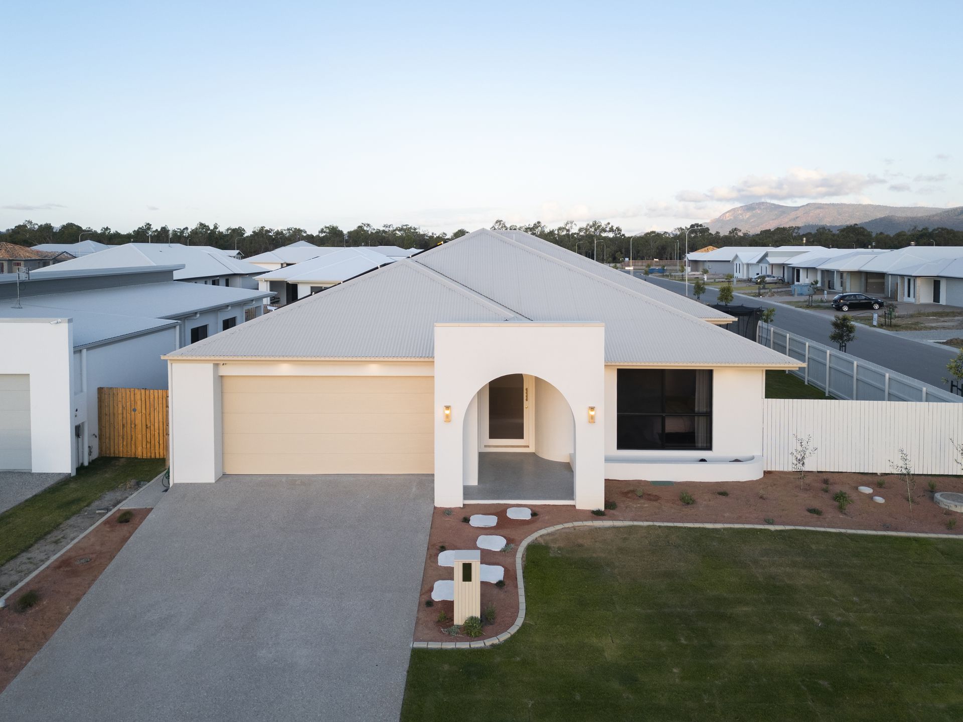 Modern Single-story White House With a Beige Garage — Simon Bell Constructions in Alice River, QLD