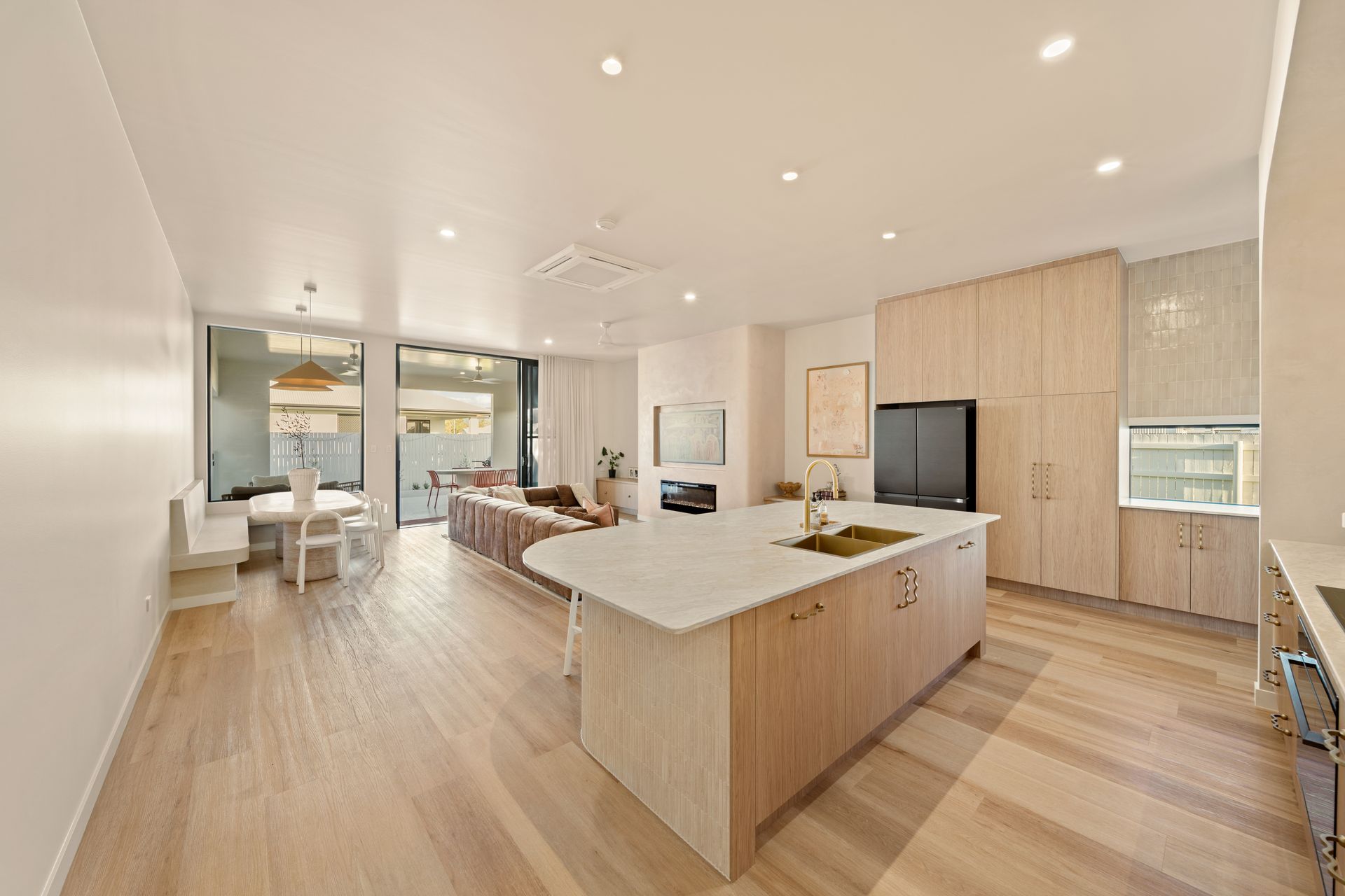 Bright Open-Plan Kitchen and Living Room With Wood Floors — Simon Bell Constructions in Alice River, QLD