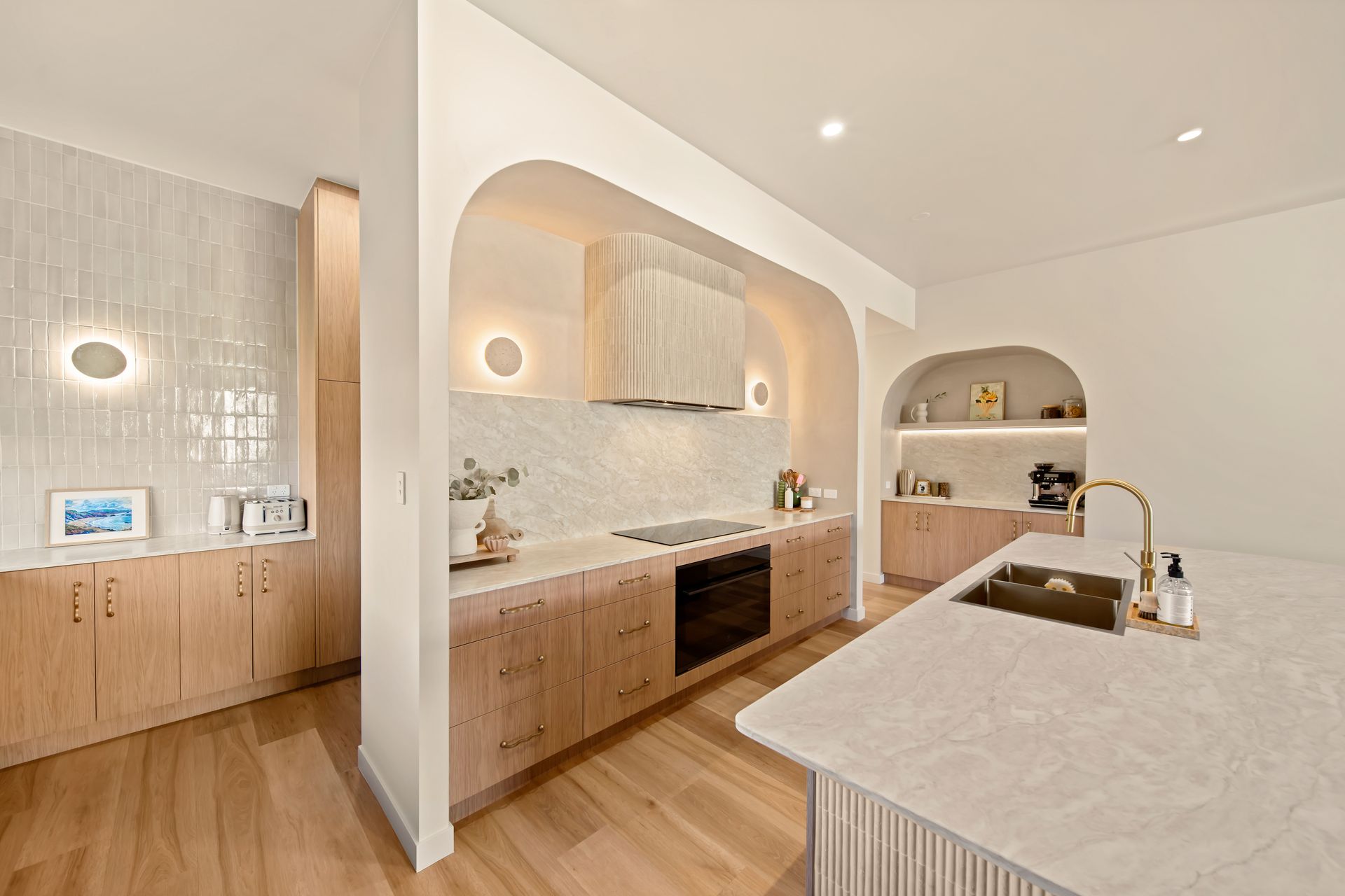 Modern Beige Kitchen With Arched Alcoves, Wood Cabinets — Simon Bell Constructions in Alice River, QLD