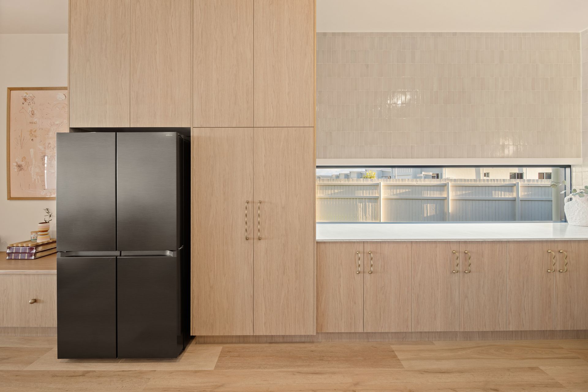 Modern Kitchen With Black Refrigerator — Simon Bell Constructions in Alice River, QLD