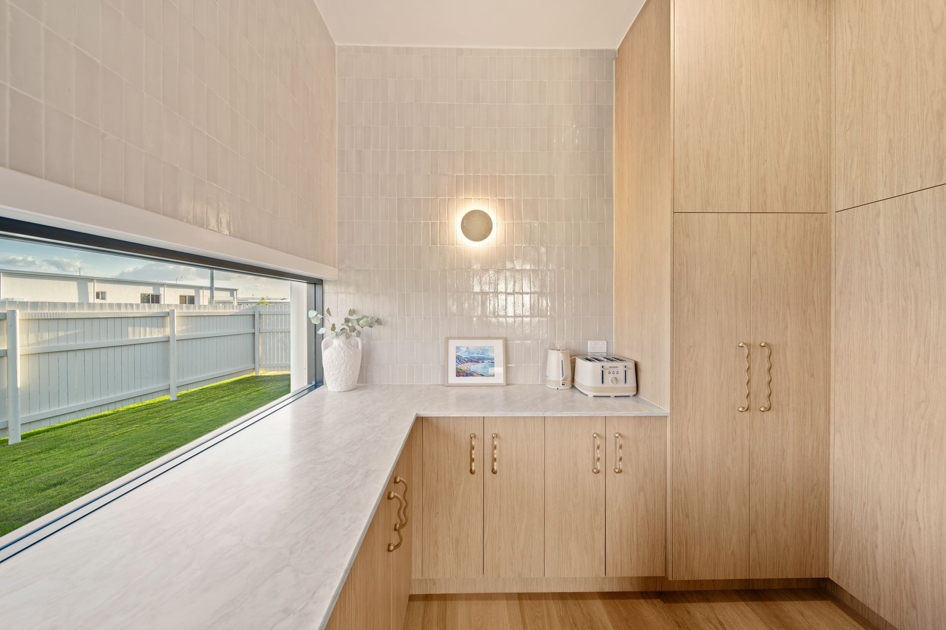 Bright, Modern Laundry Room With Light Wood Cabinets — Simon Bell Constructions in Alice River, QLD
