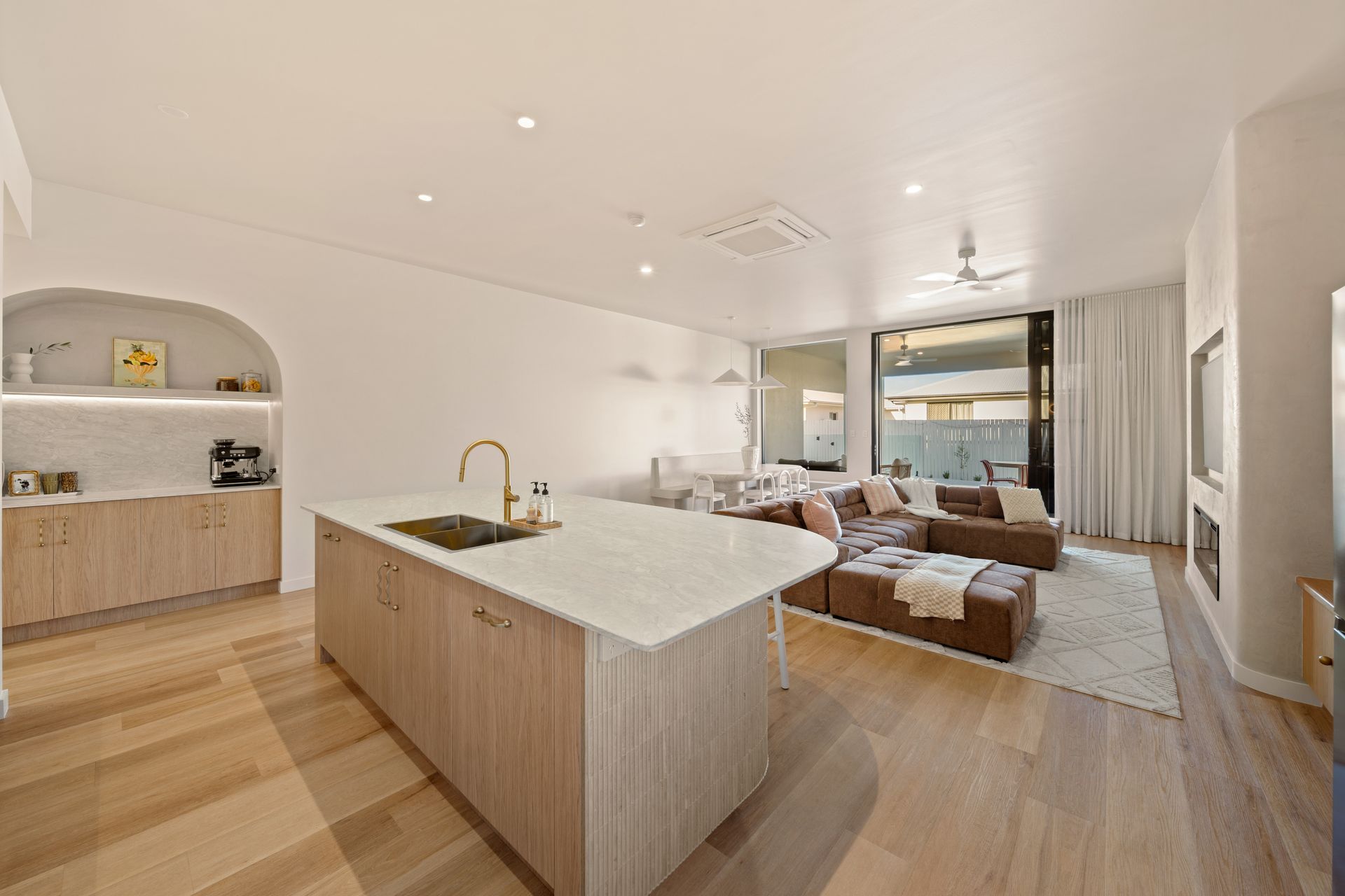 Bright Modern Open-plan Living Room and Kitchen With Wood Floors, White Walls — Simon Bell Constructions in Alice River, QLD