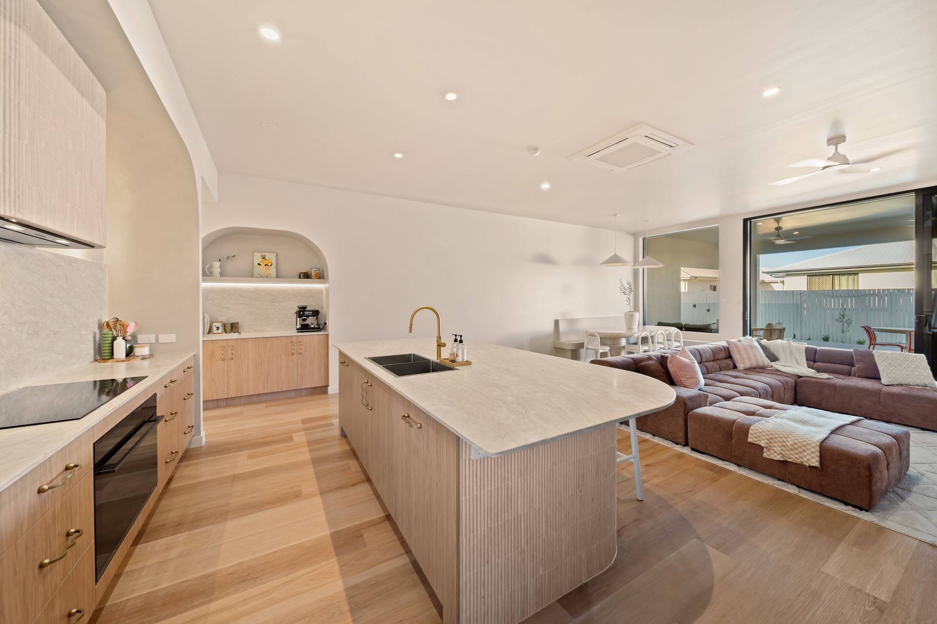 Bright Open-Plan Kitchen and Living Room With Wood Floors — Simon Bell Constructions in Alice River, QLD