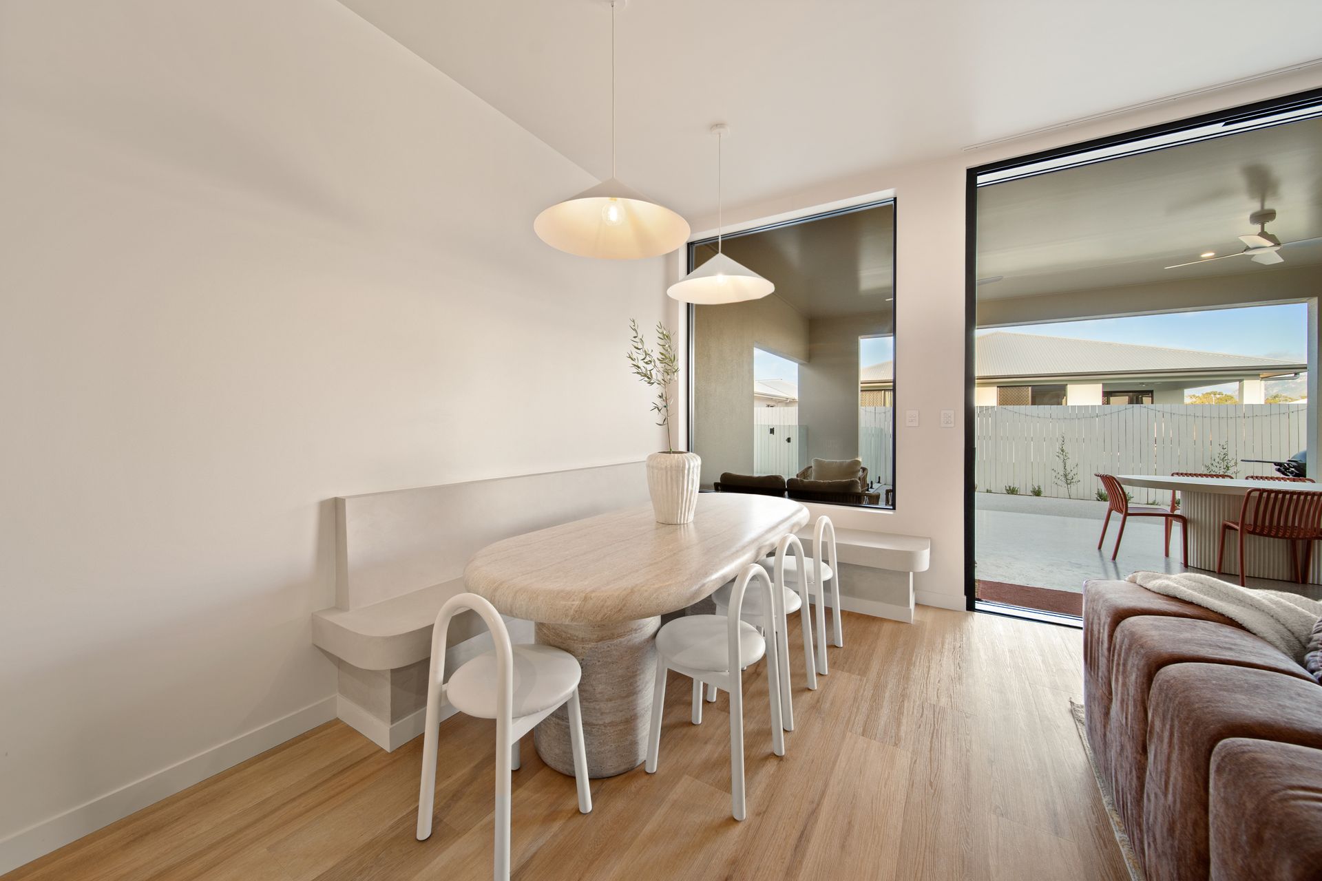 Bright Dining Area With a White Table, Chair — Simon Bell Constructions in Alice River, QLD