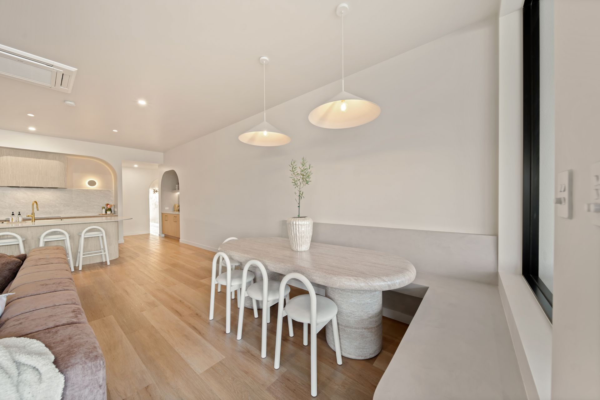 Bright Minimalist Dining and Living Room With White Chairs — Simon Bell Constructions in Alice River, QLD