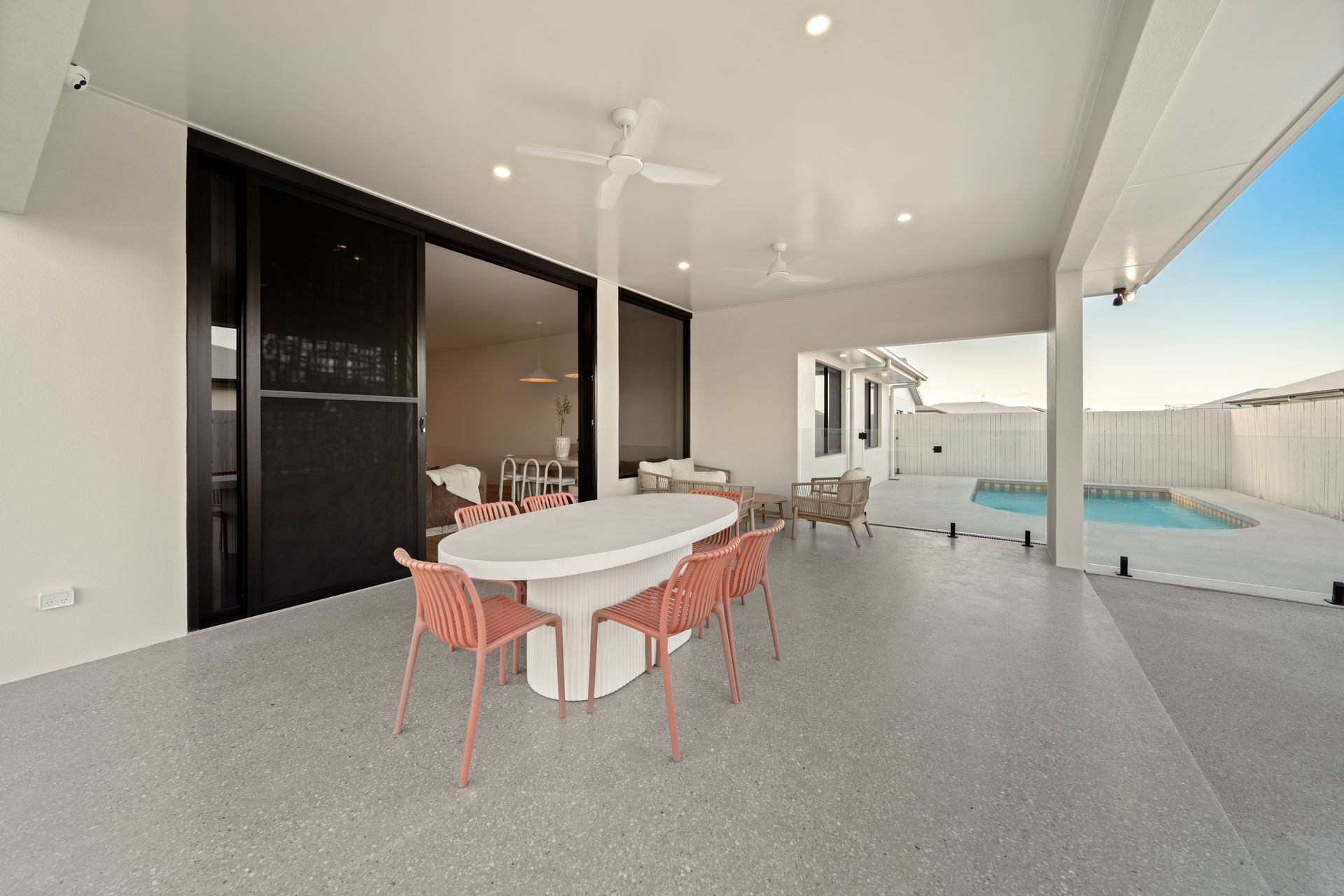 Covered Patio With Dining Table, Chairs, Outdoor Kitchen, and Pool View — Simon Bell Constructions in Alice River, QLD