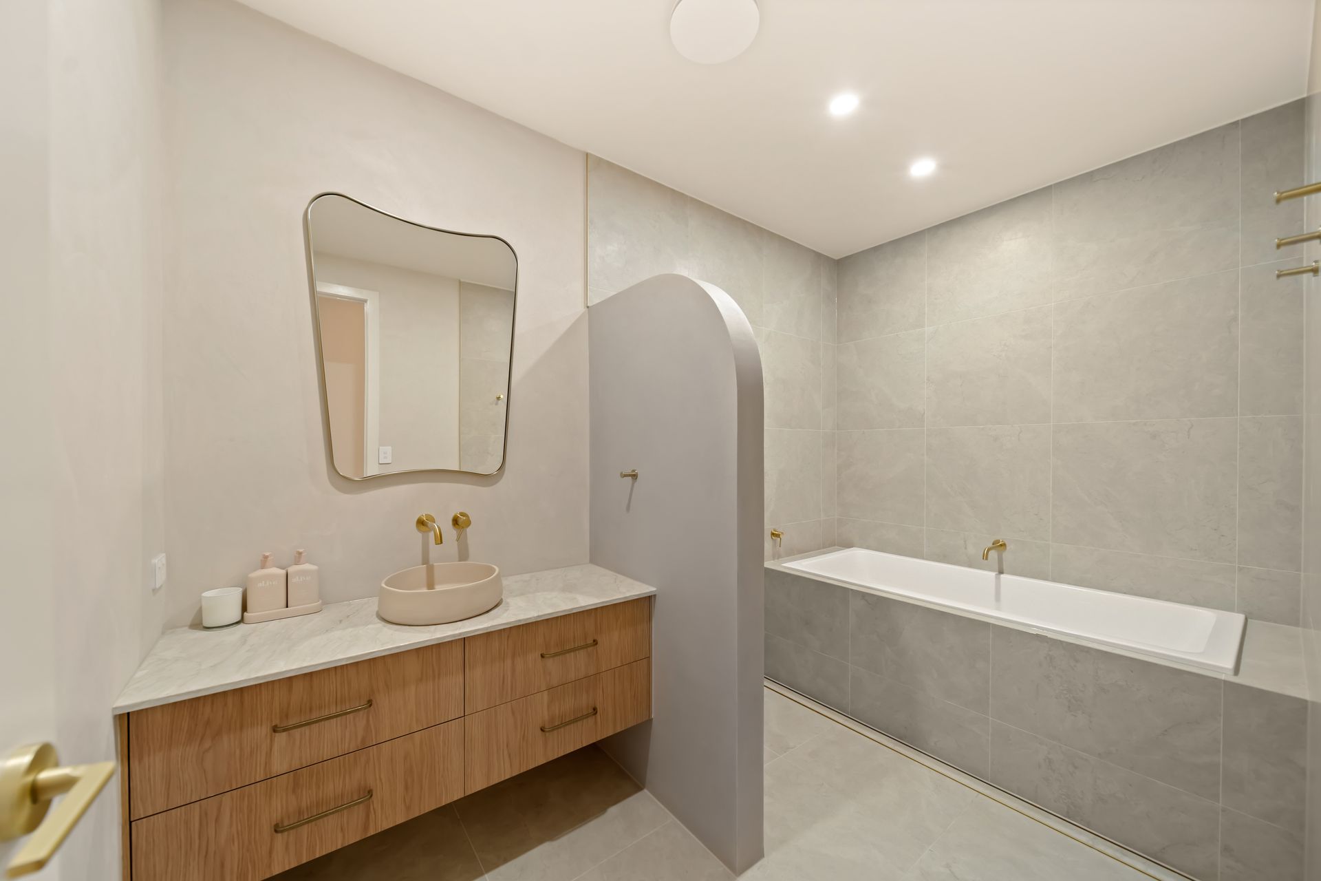 Modern Bathroom With Wooden Vanity, Mirror, White Bathtub — Simon Bell Constructions in Alice River, QLD