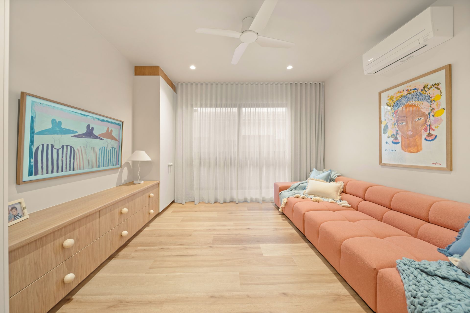 Bright Modern Living Room With Coral Sofa — Simon Bell Constructions in Alice River, QLD