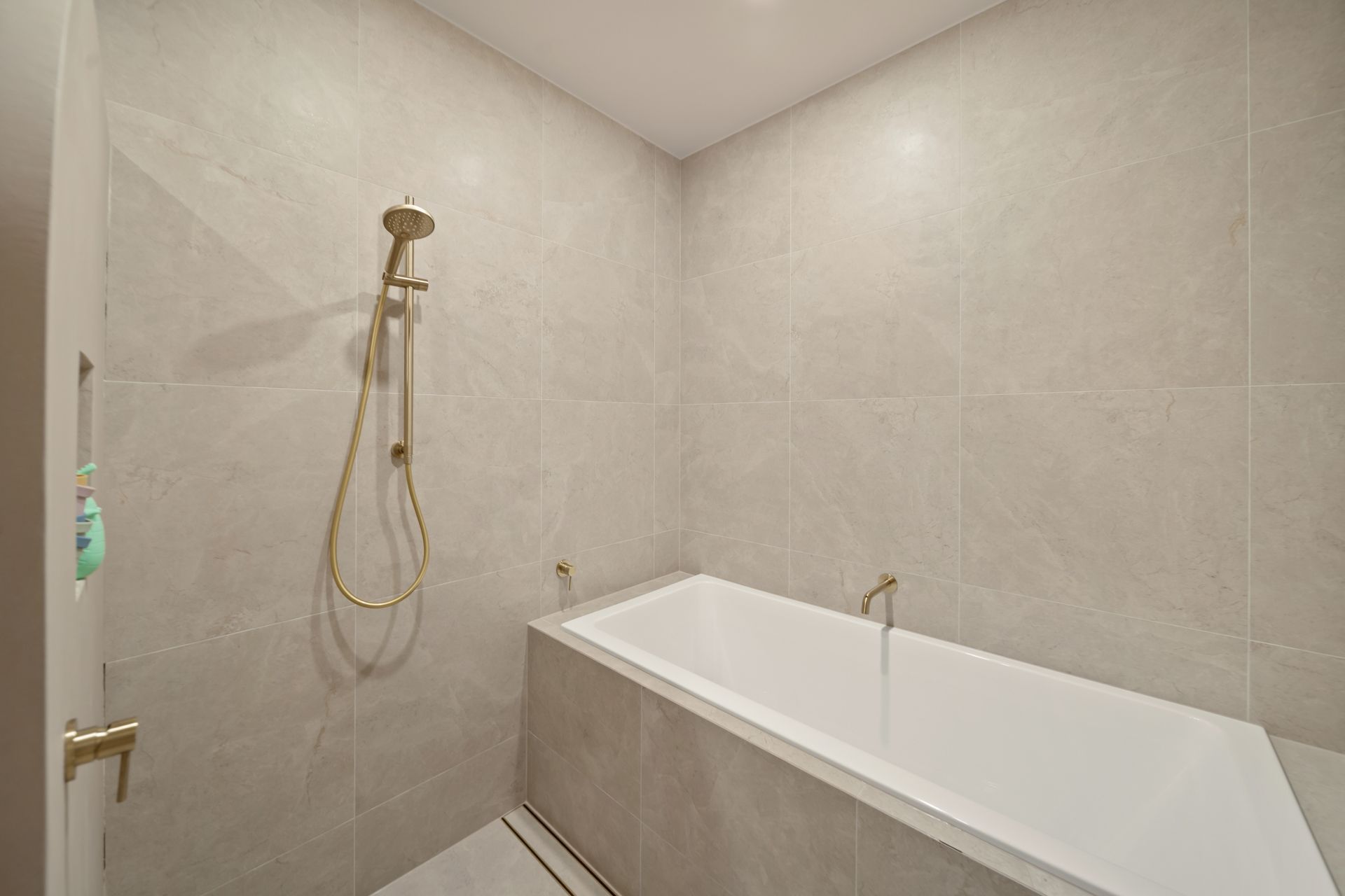 Modern Bathroom With Beige Tile, a Showerhead — Simon Bell Constructions in Alice River, QLD