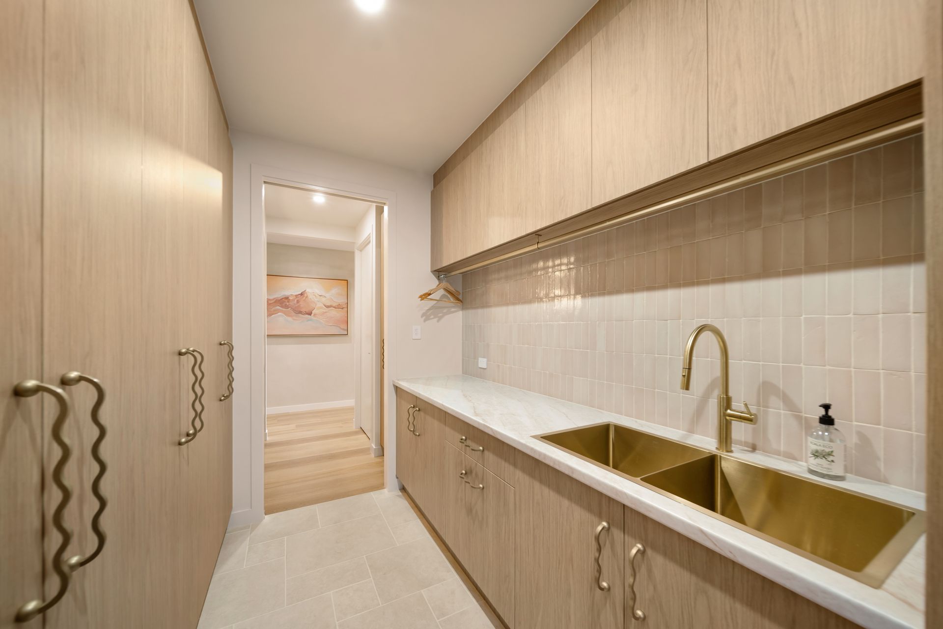 Narrow Light-wood Kitchen Corridor With White Counters — Simon Bell Constructions in Alice River, QLD