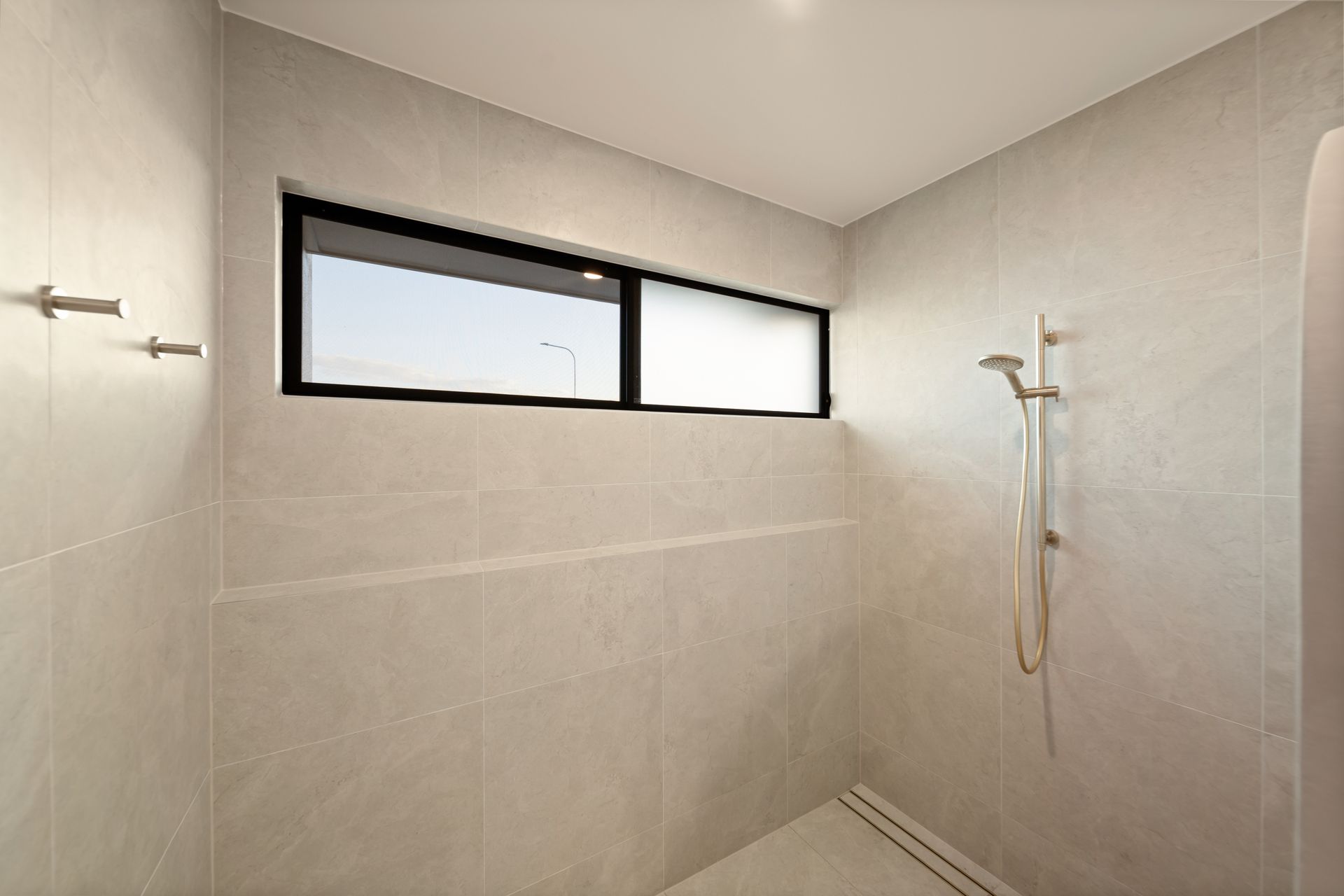 Modern Tiled Shower With Frosted Window — Simon Bell Constructions in Alice River, QLD
