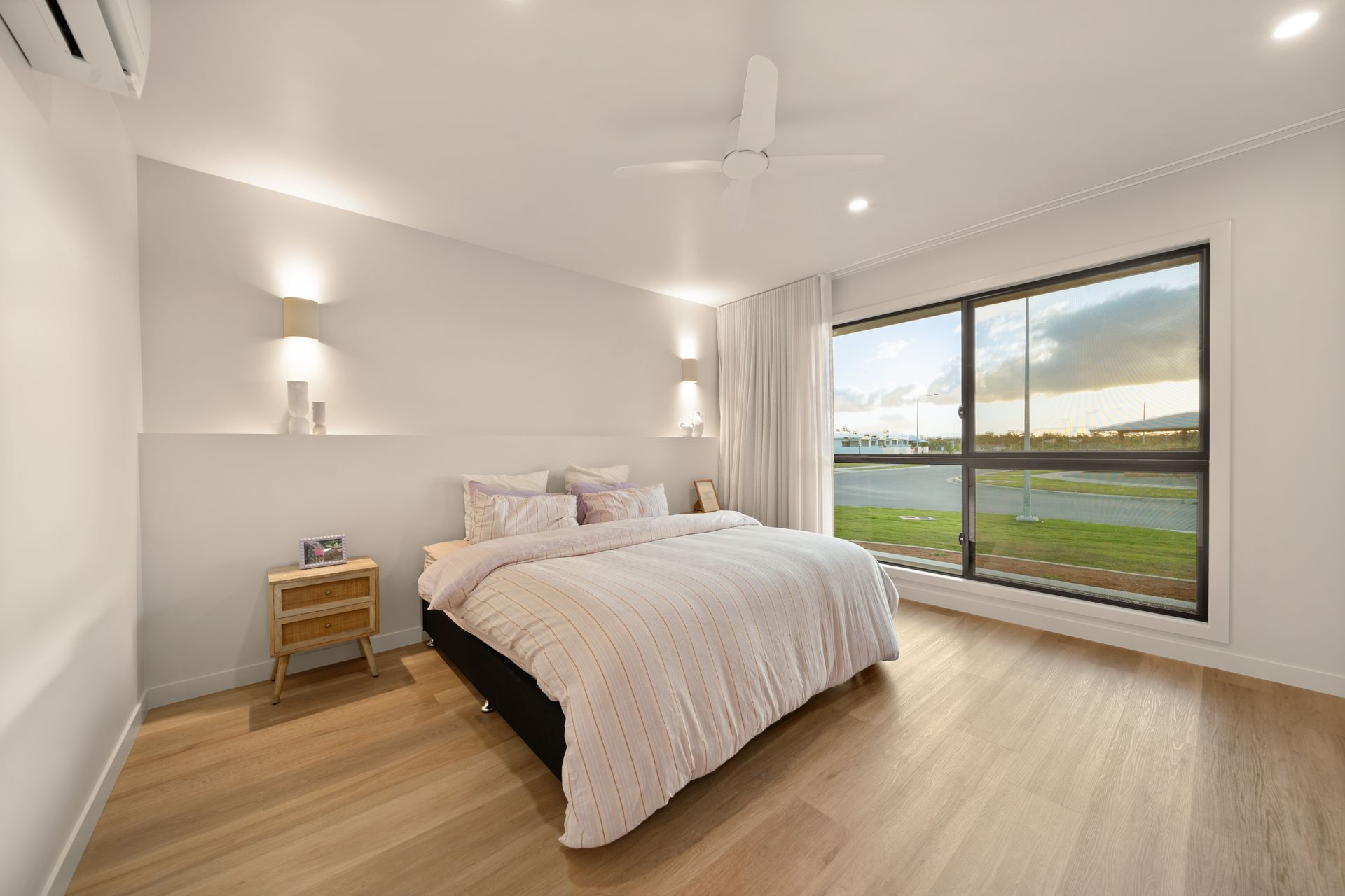 Bright Modern Bedroom With a Bed, Bedside Table — Simon Bell Constructions in Alice River, QLD