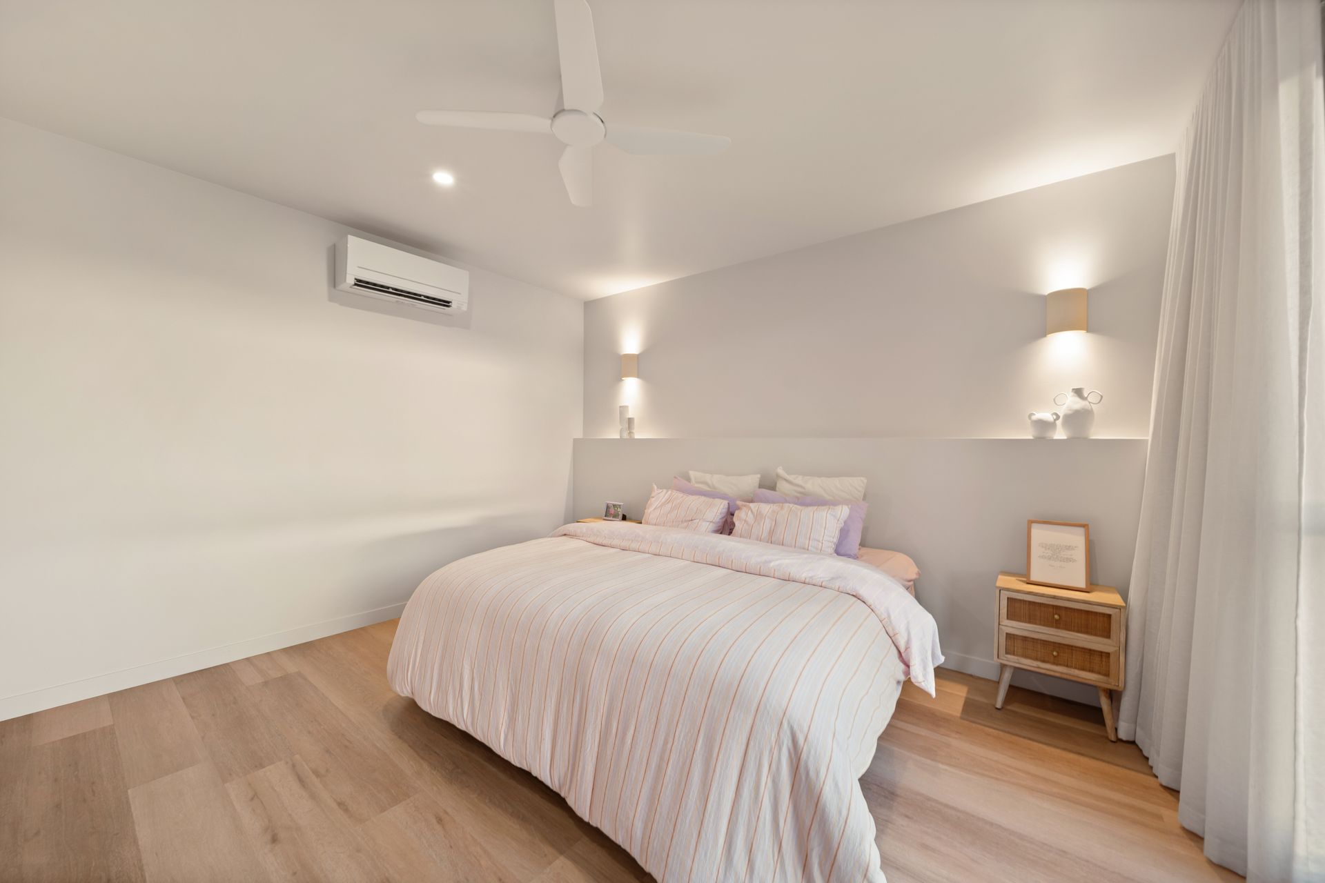 Bright Minimalist Bedroom With a Double Bed, Wooden Floor — Simon Bell Constructions in Alice River, QLD