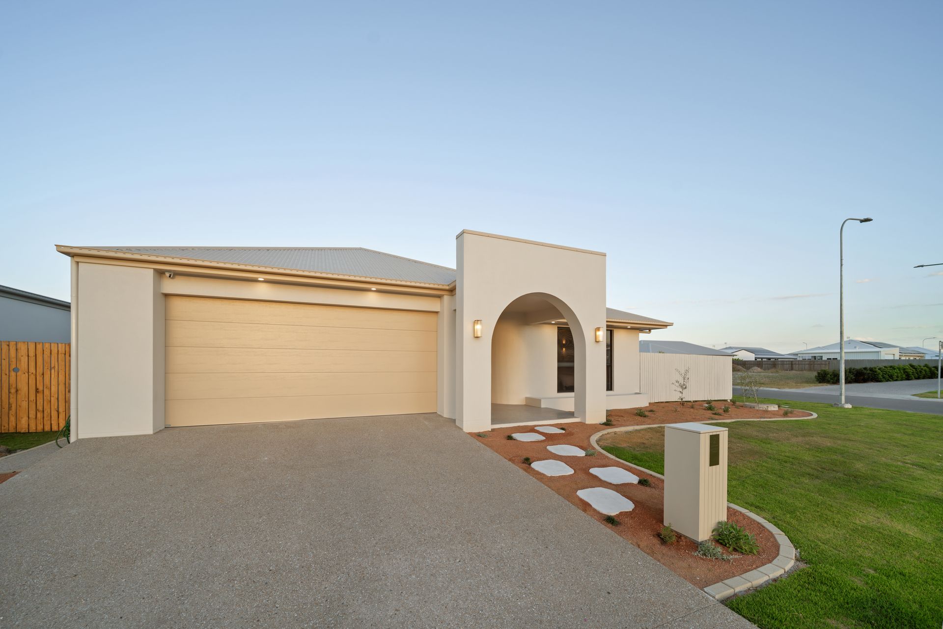 Modern Suburban House With Beige Garage, Arched Entryway — Simon Bell Constructions in Alice River, QLD