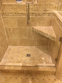 a bathroom with a walk-in shower with a glass door