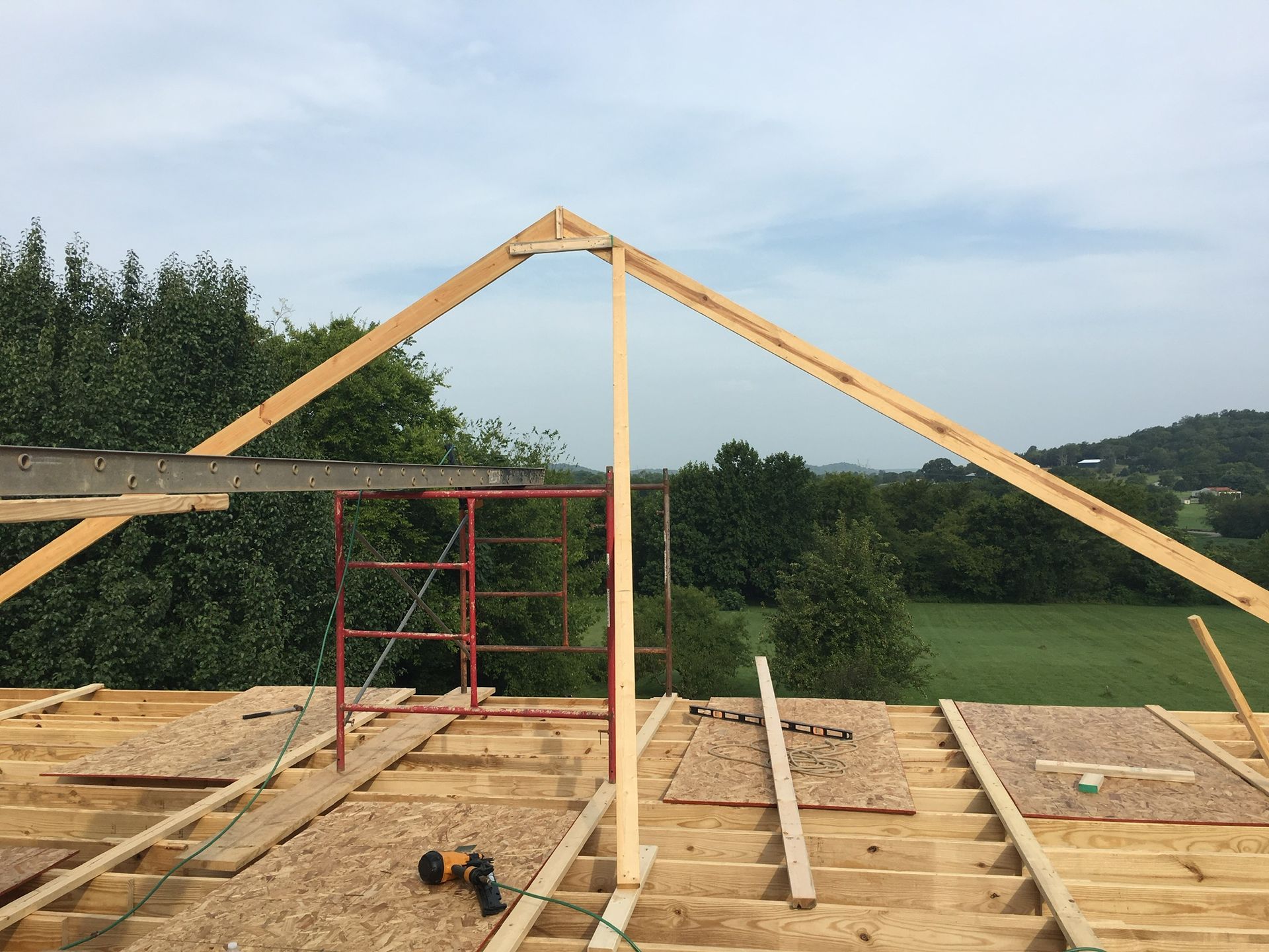 a wooden structure is being built on top of a dirt field