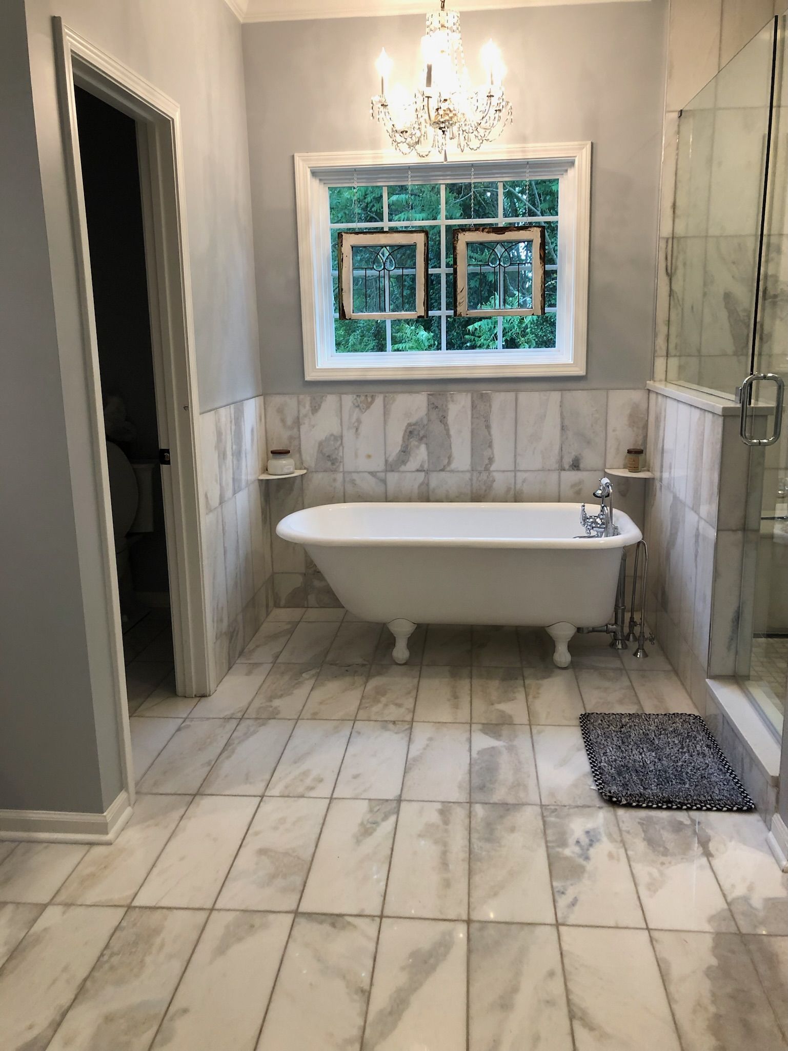 a bathroom with a bathtub and a window