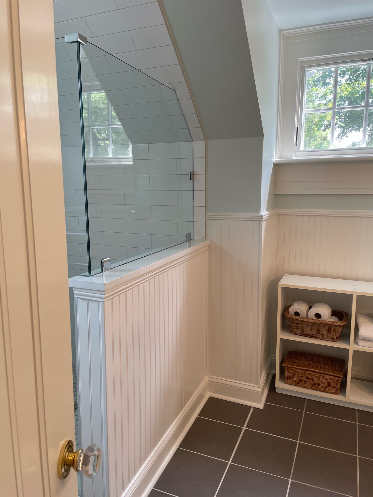 a bathroom with a walk in shower and a window