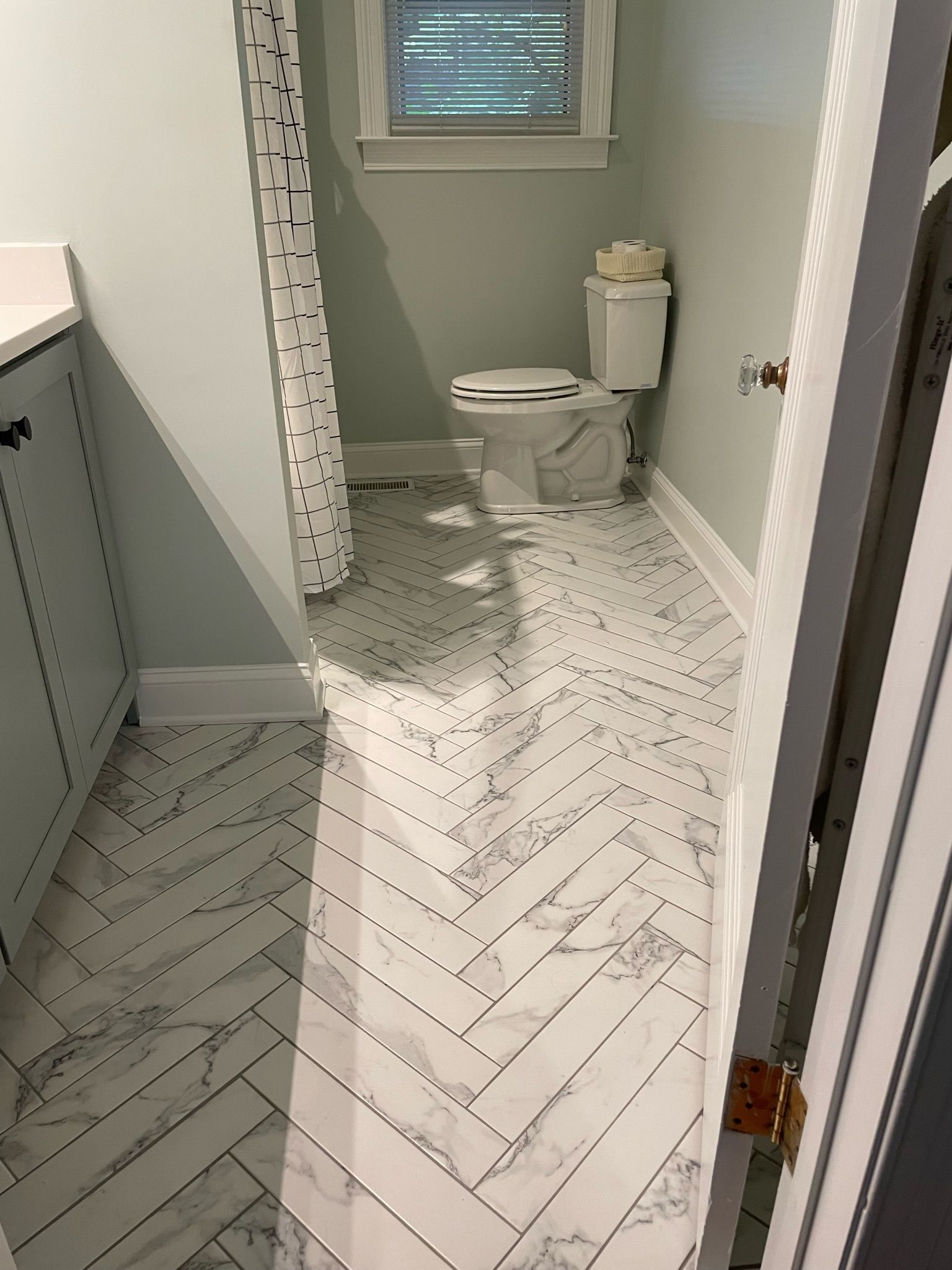 a bathroom with a toilet and a shower curtain